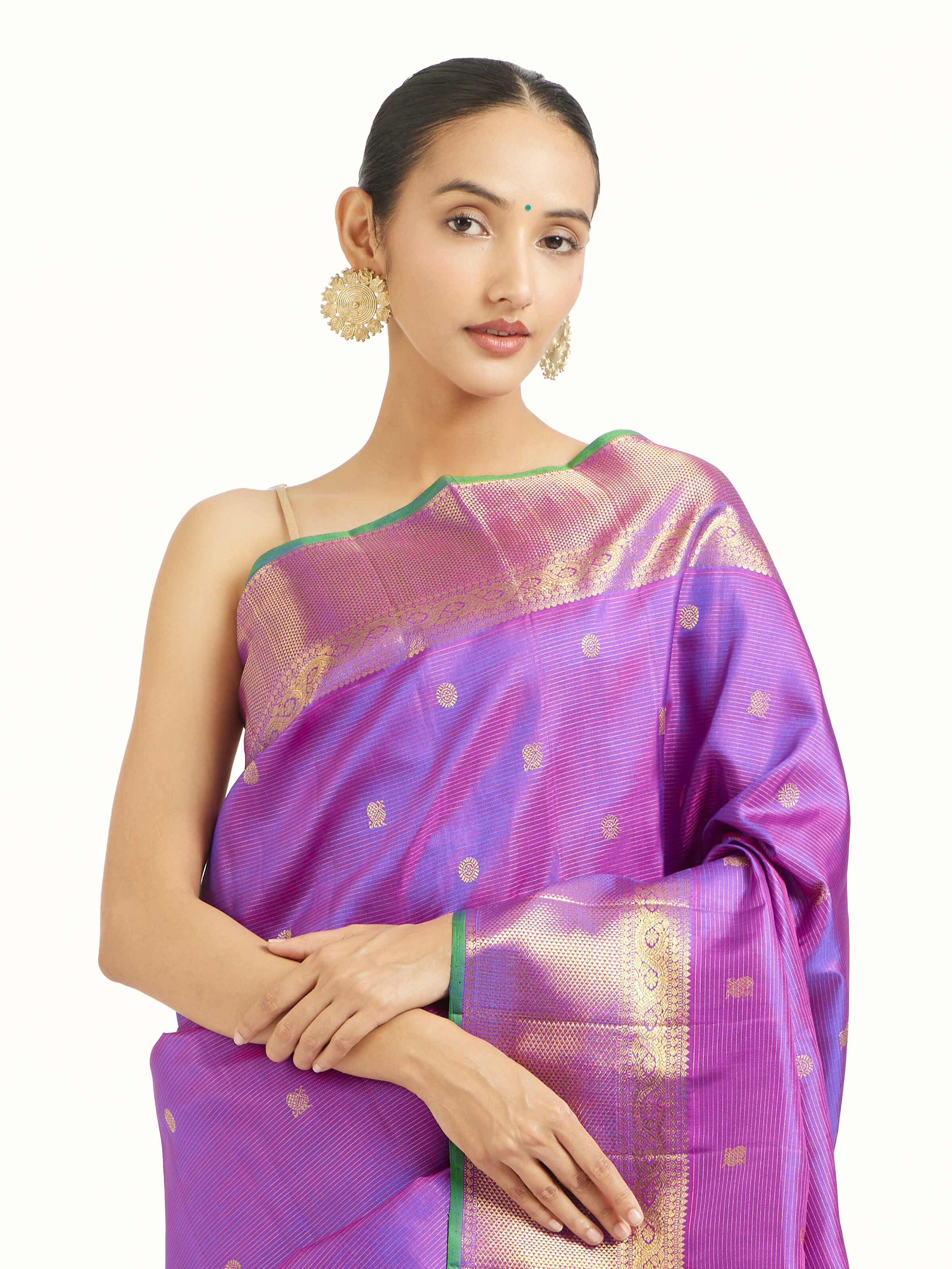 Angled view of purple silk Kancheepuram saree highlighting woven motifs
