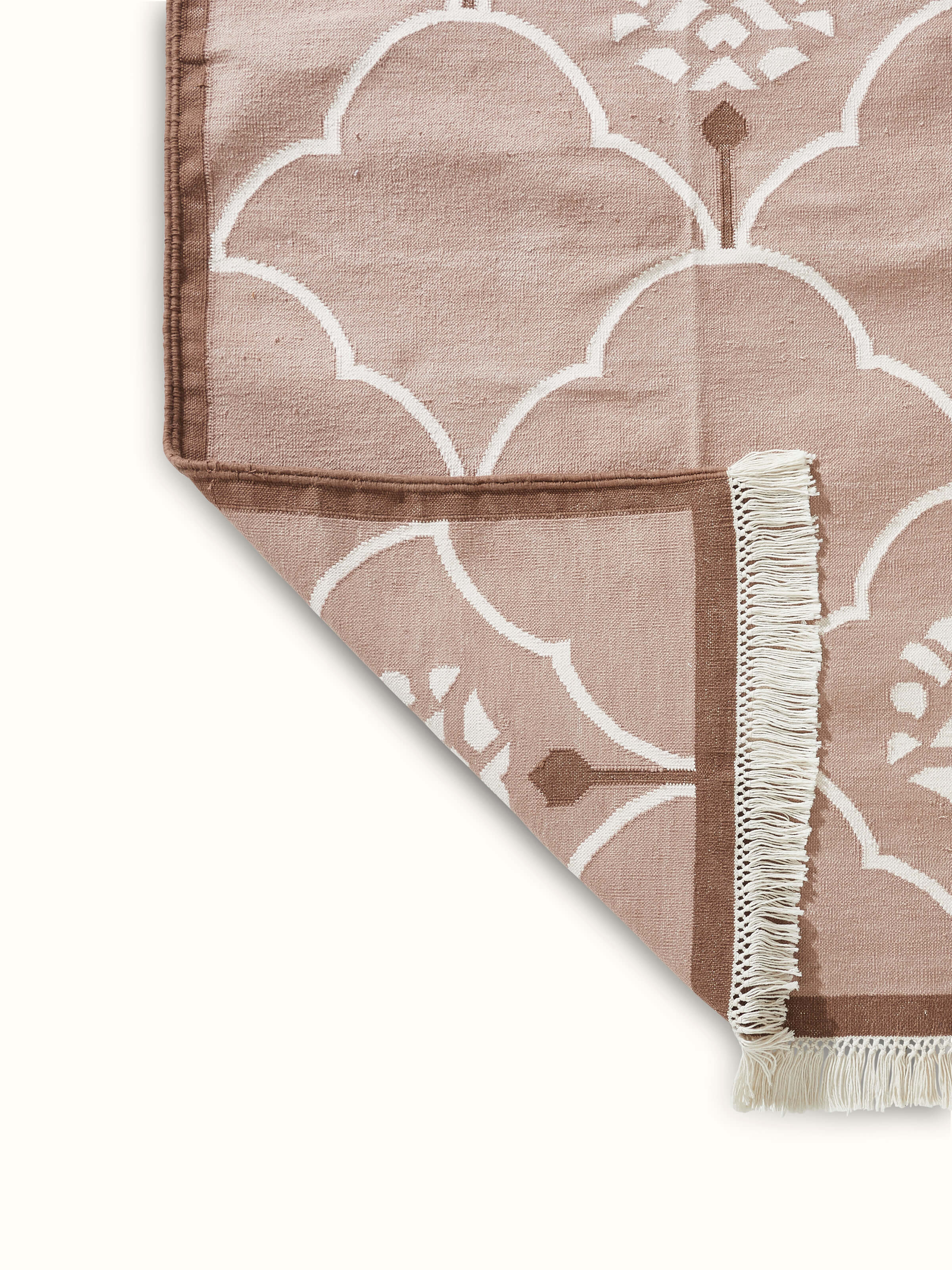 Back Side view of Stylised floral beige lawan cotton panja dhurrie highlighting its traditional design