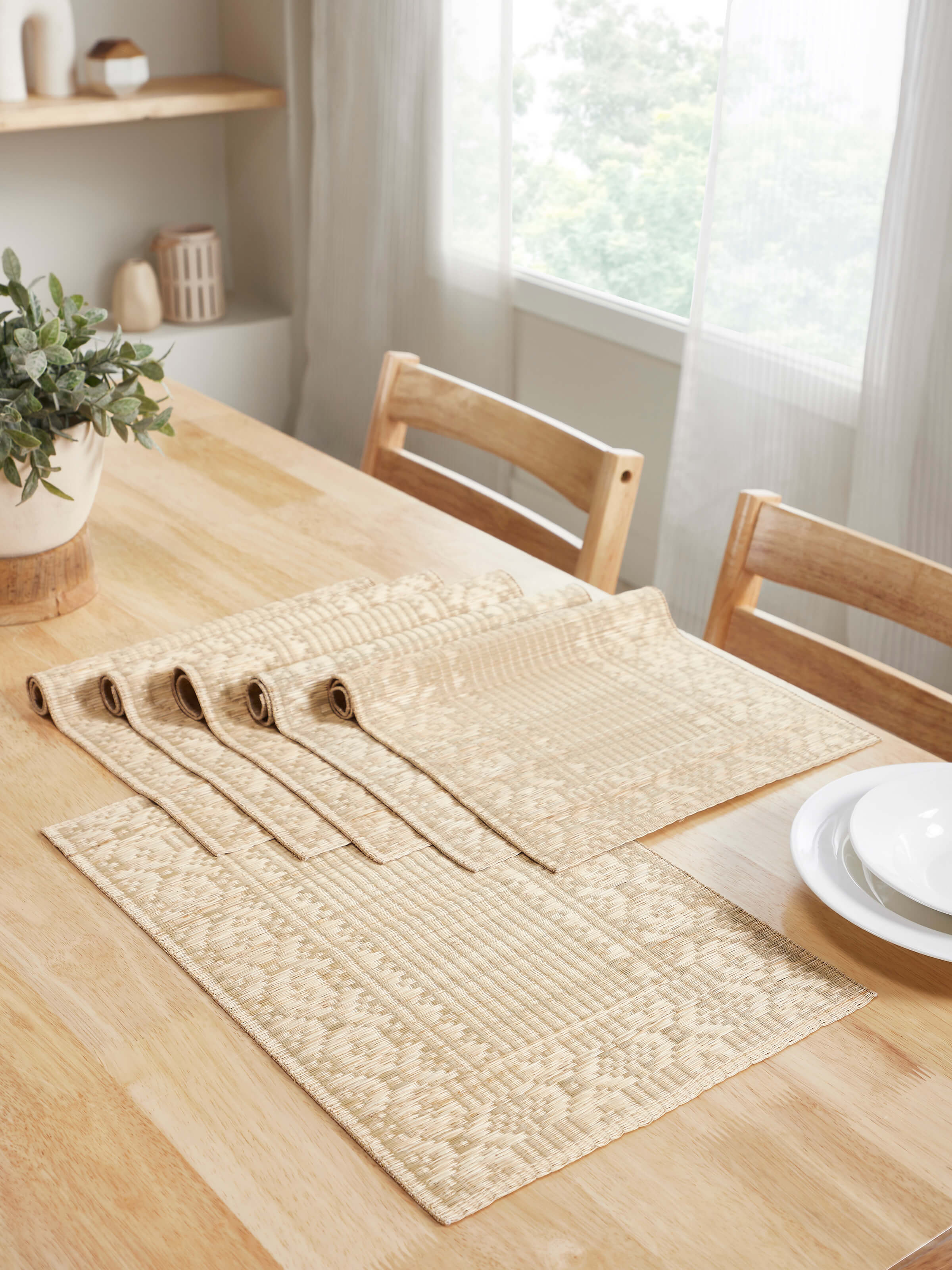 Lifestyle view of Prakriti Beige Folk Geo Table Mats arranged on a rustic dining table.
