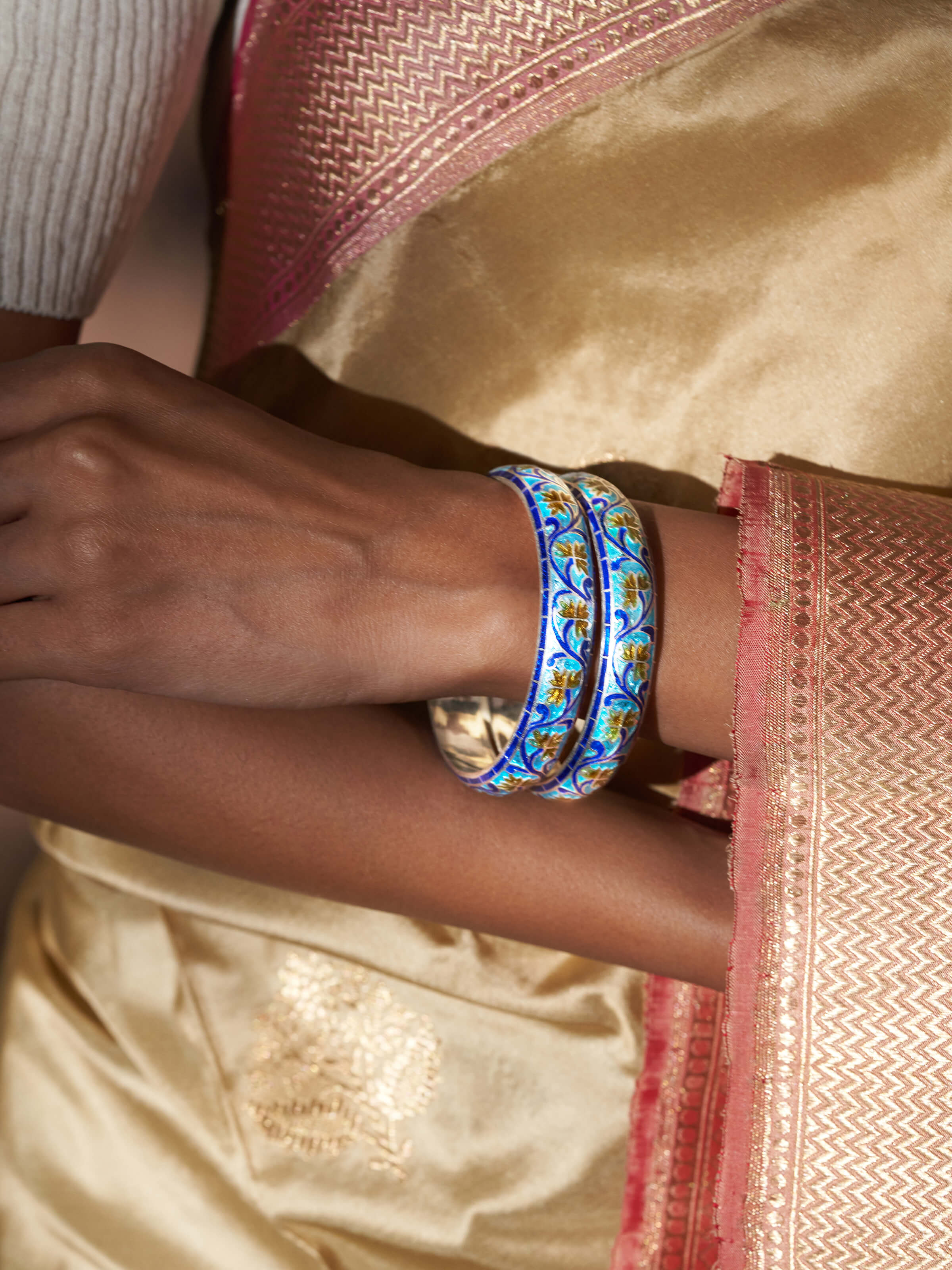 Side view of blue meenakari silver bangles showcasing intricate design and vibrant blue enamel.