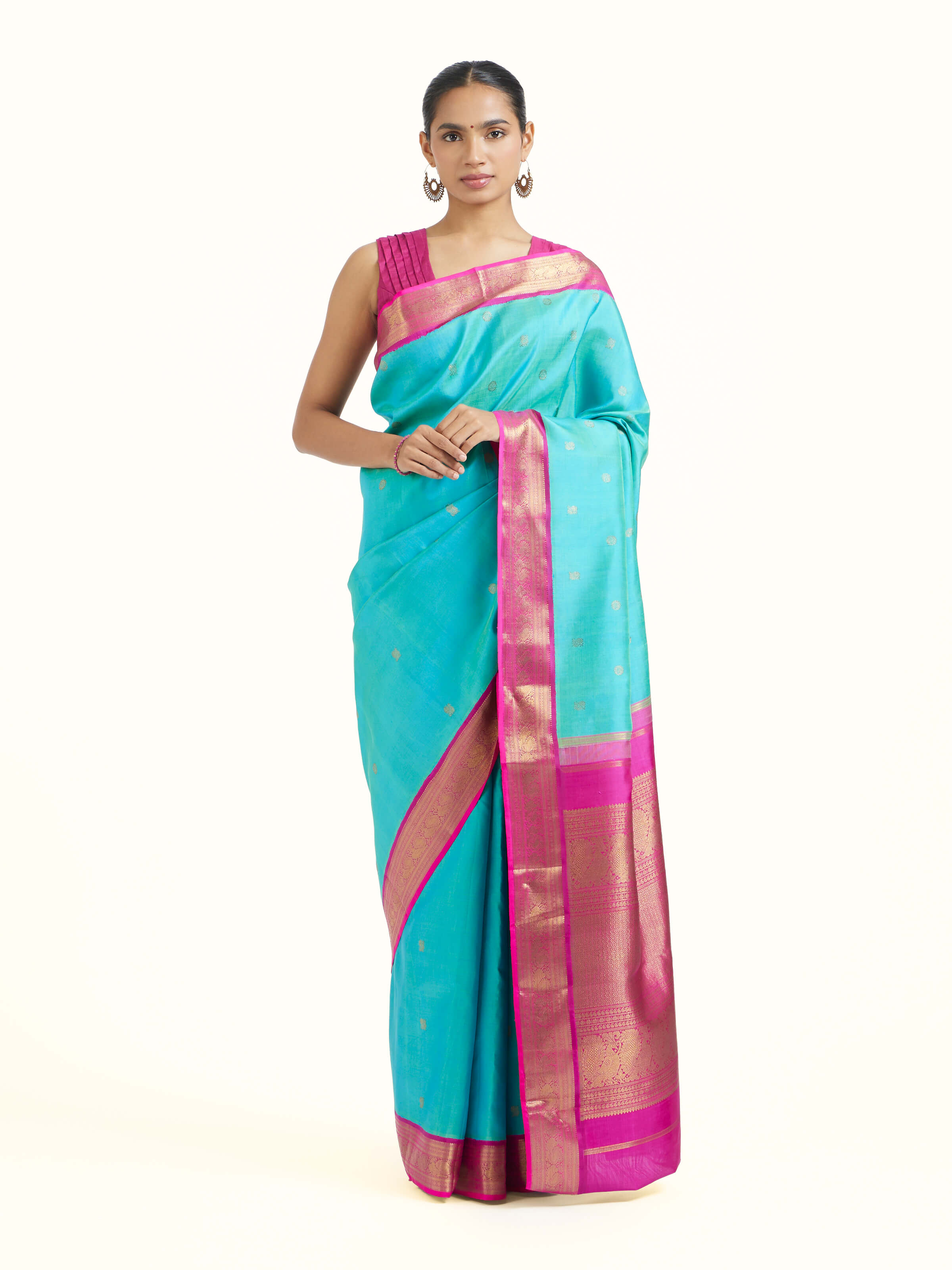 Front view of turquoise silk Kancheepuram saree showcasing vibrant tone and lustrous silk