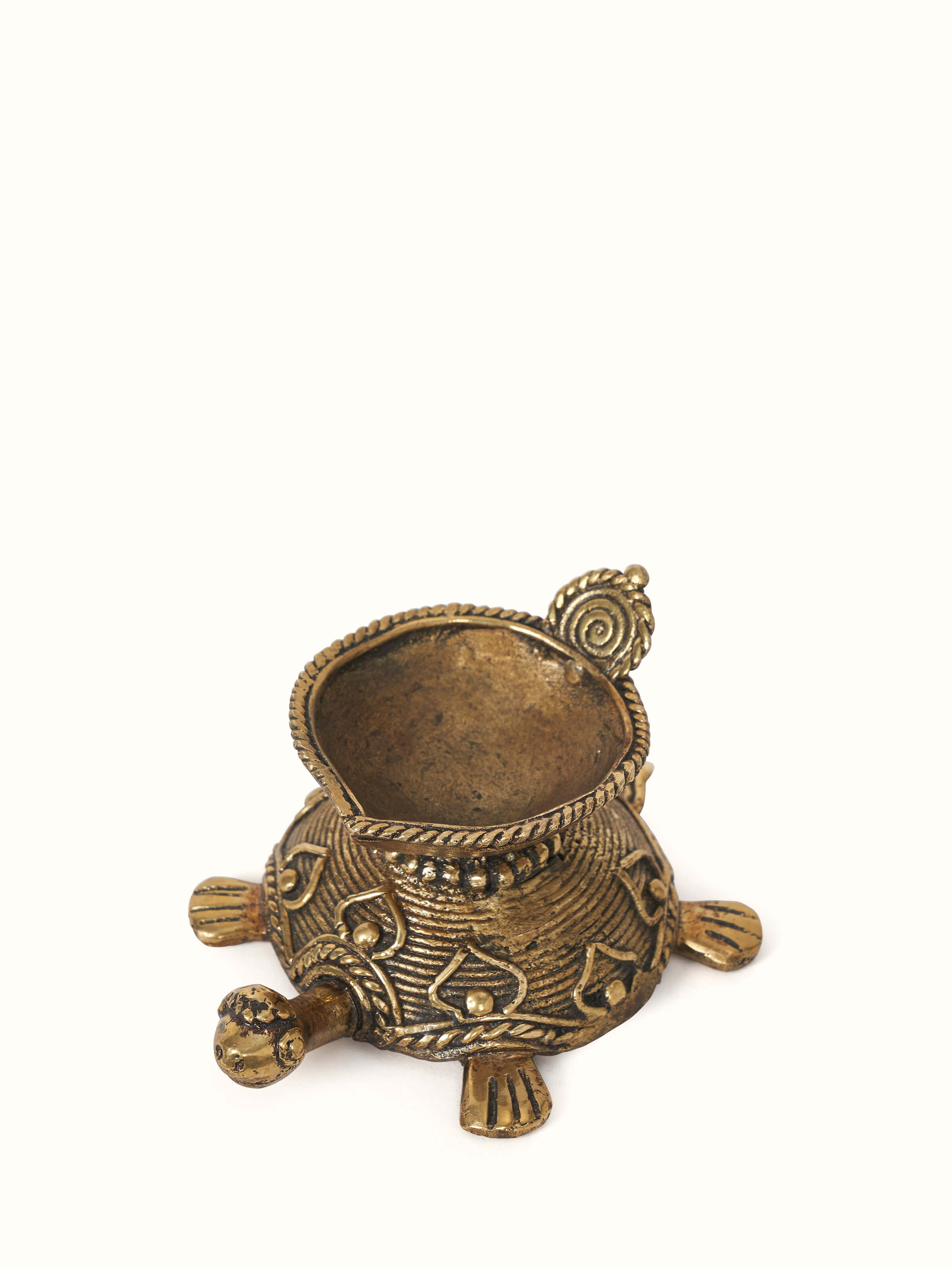 Close-up of Dhokra Brass Diya focusing on the intricate patterns and fine details of the brasswork.