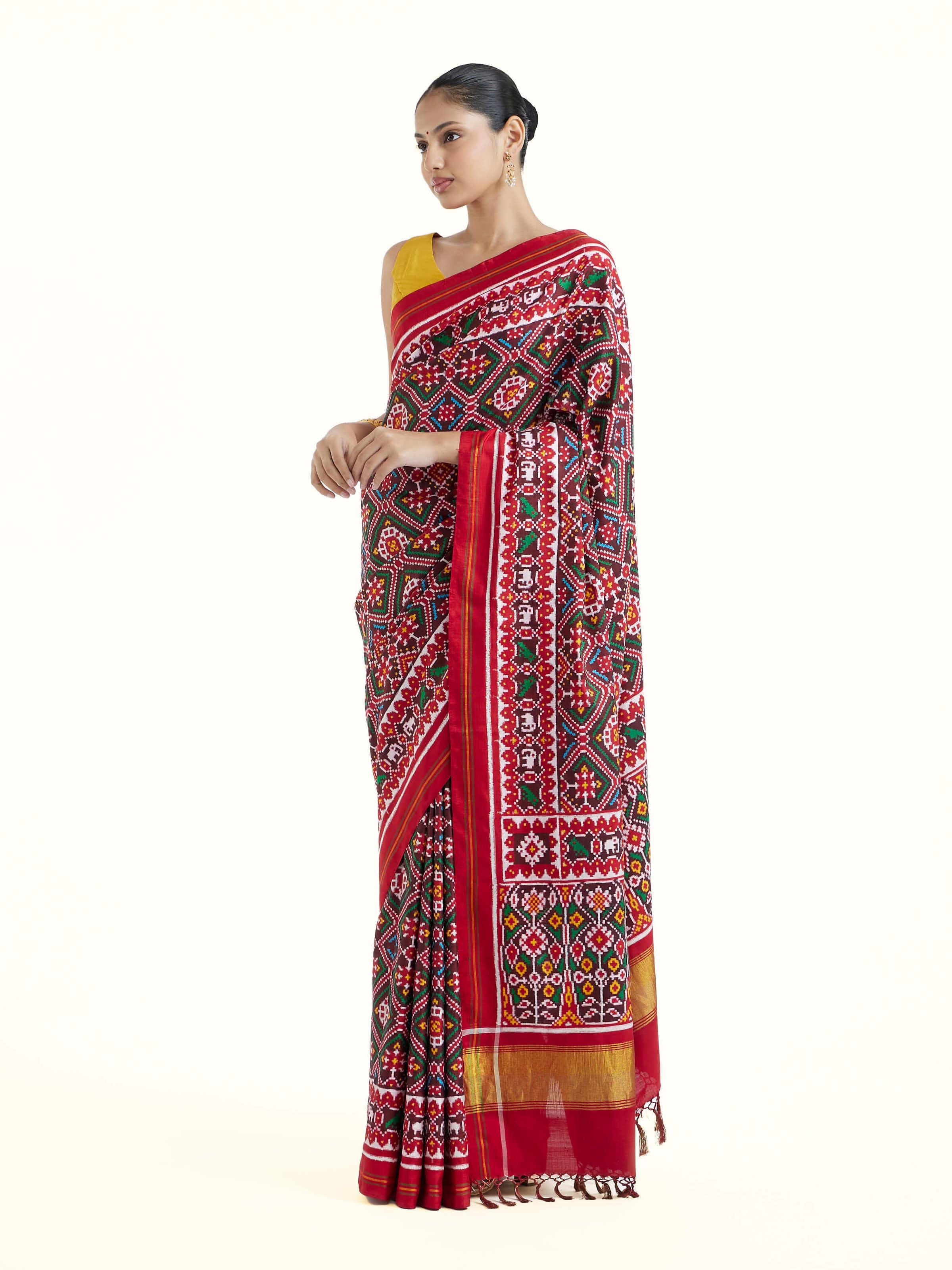 Side view of brown silk Patola saree highlighting rich silk drape