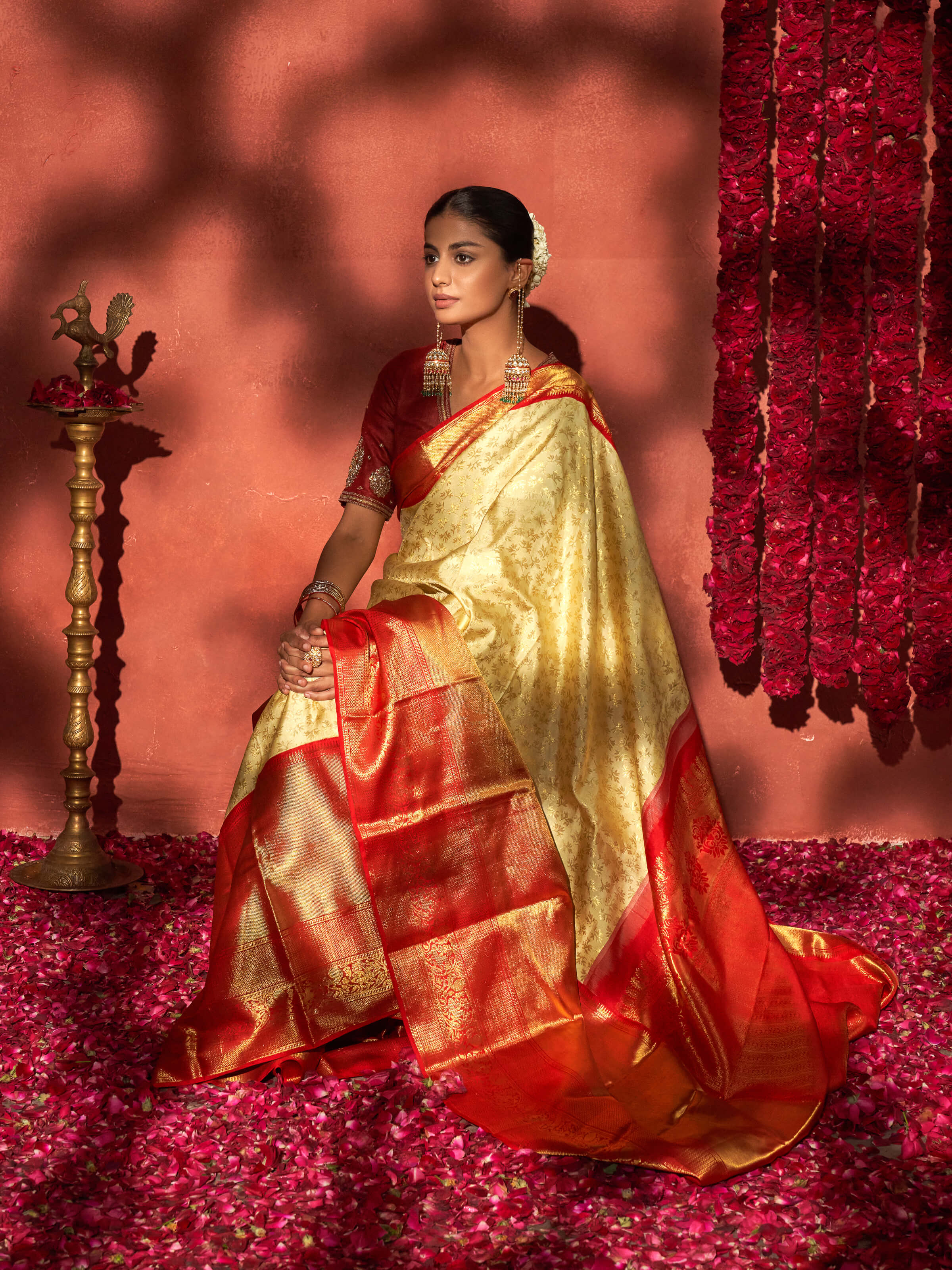 Angled view of off-white silk Dharmavaram saree showcasing full design and sheen