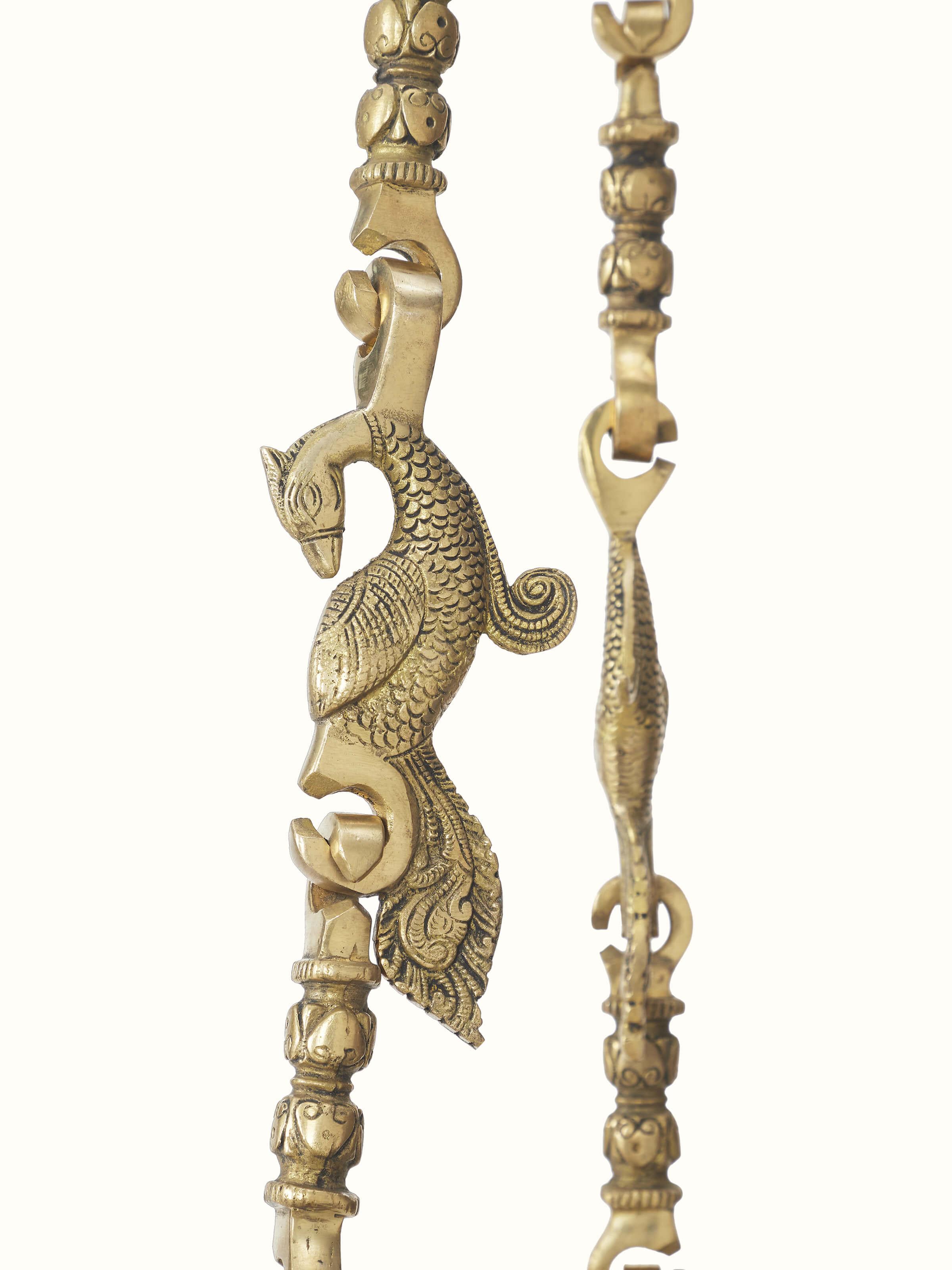 Detailed view of the Sheesham wood swing's carving patterns and brass fittings, showcasing the intricate craftsmanship.