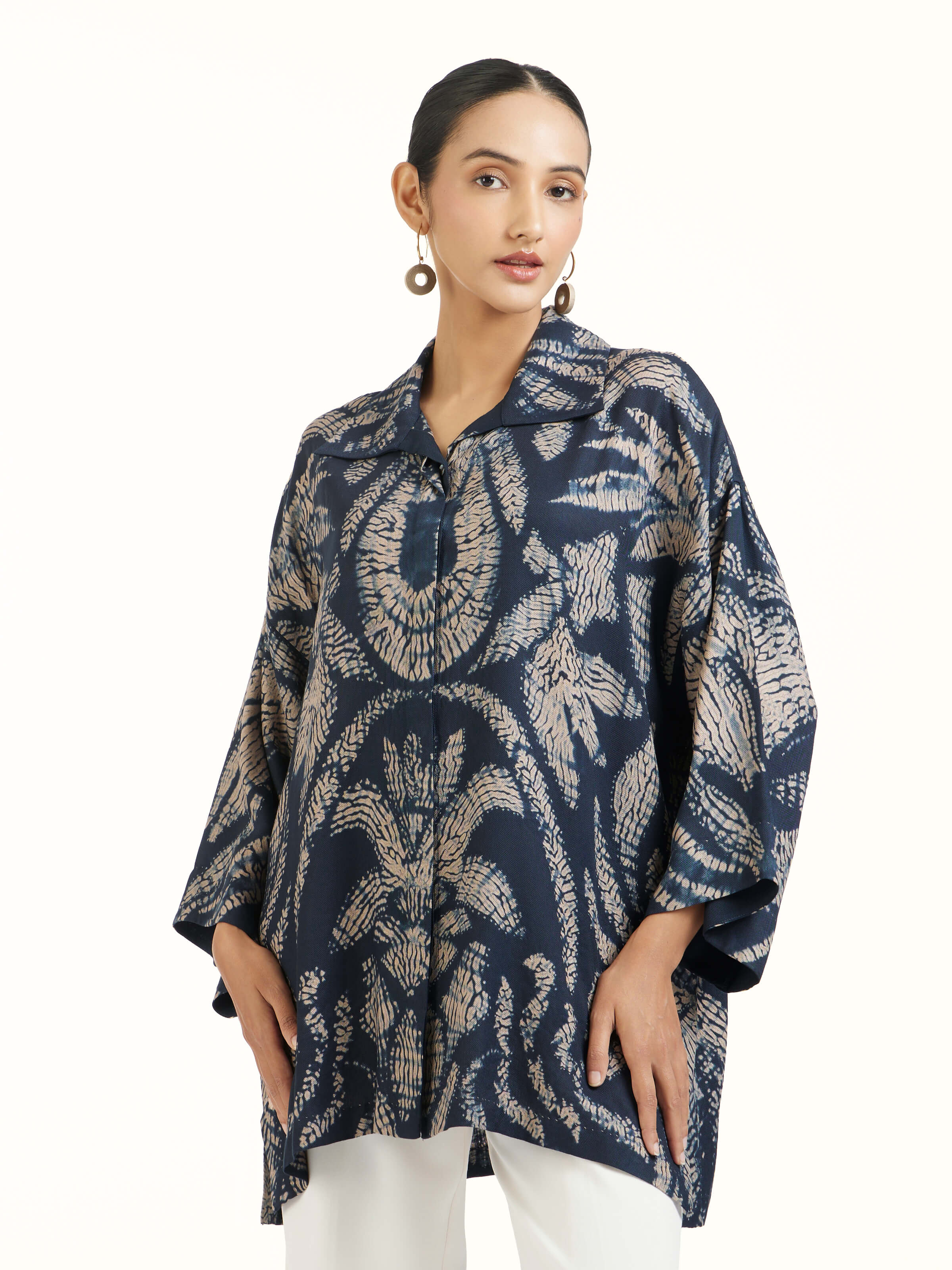 Angled view of blue modal shibori shirt emphasizing tonal dyeing and fabric flow