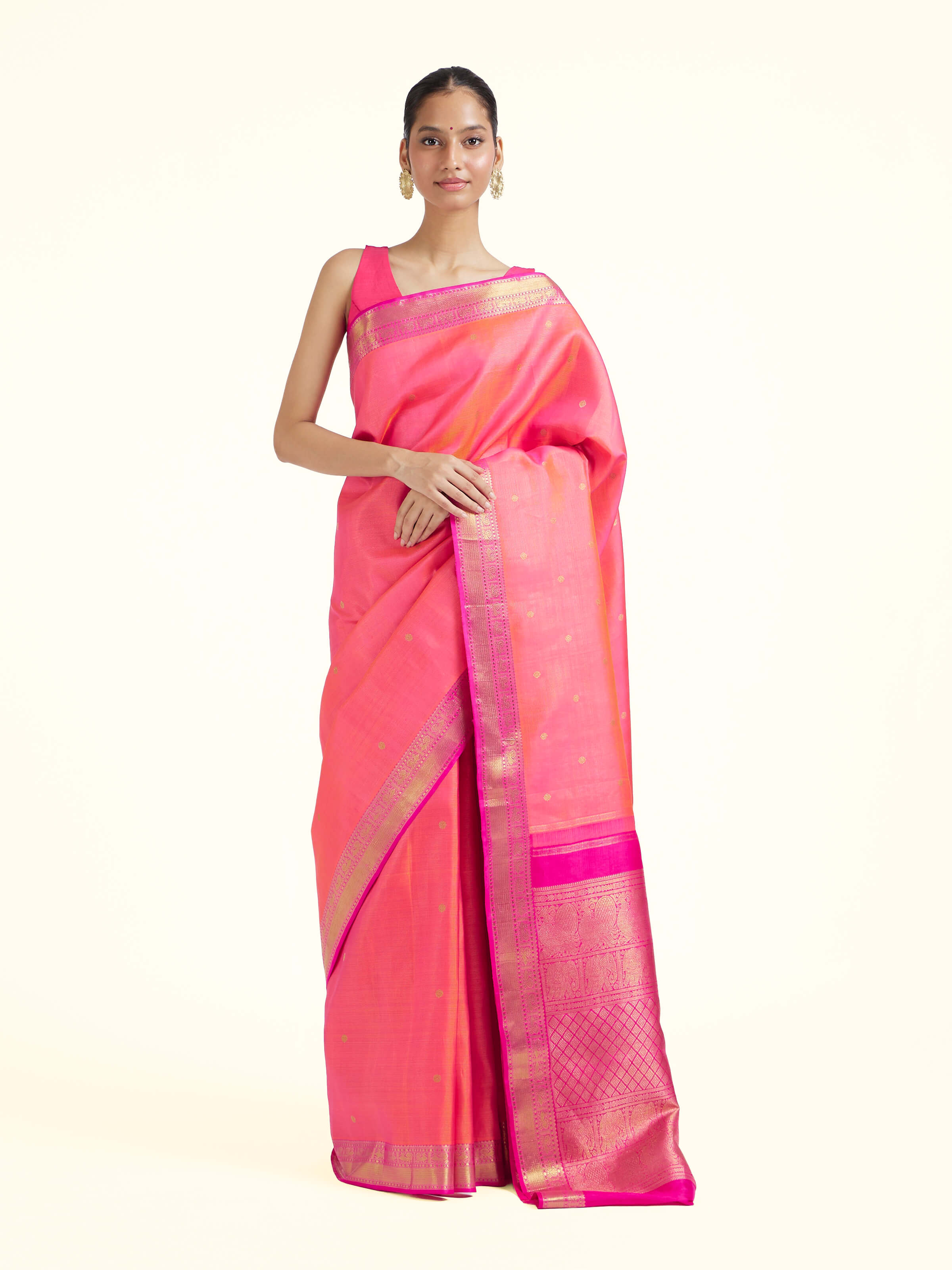 Front view of pink silk Kancheepuram saree with rich zari woven motifs