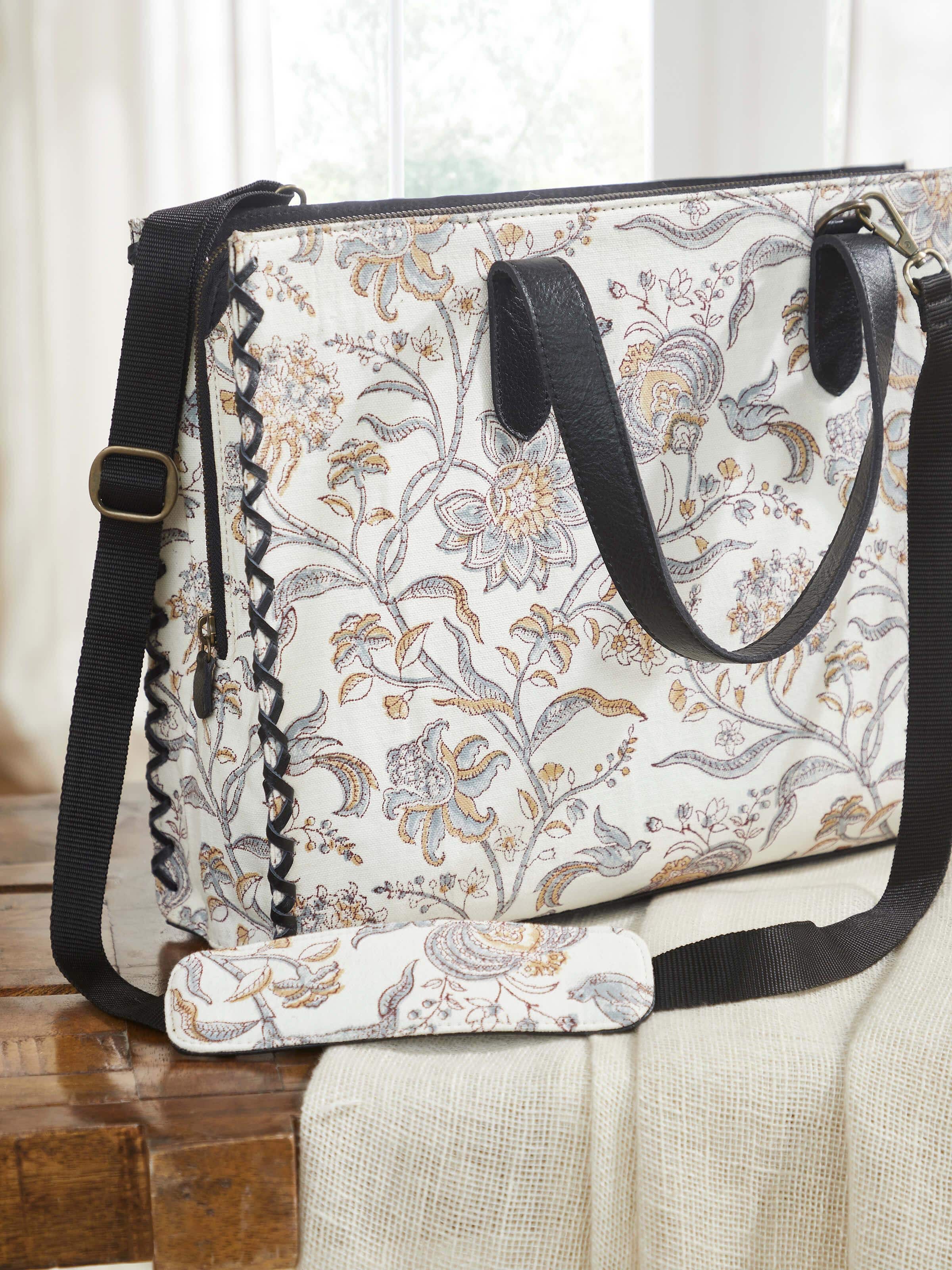 Black leather and textile hand block printed tote bag angled view highlighting bag shape and print