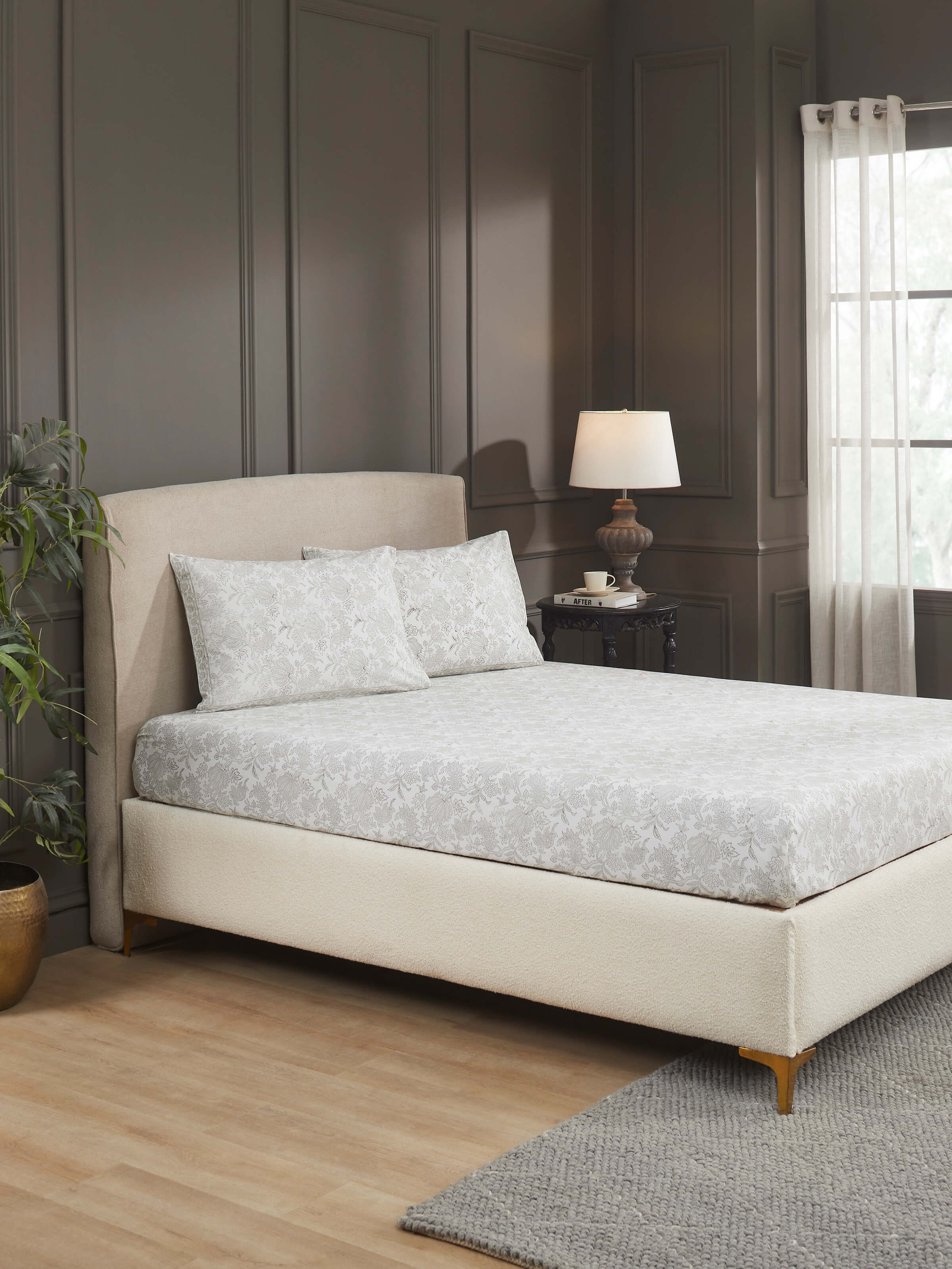 Lifestyle shot of grey floral Sanganeri cotton bedsheet set on a king-size bed