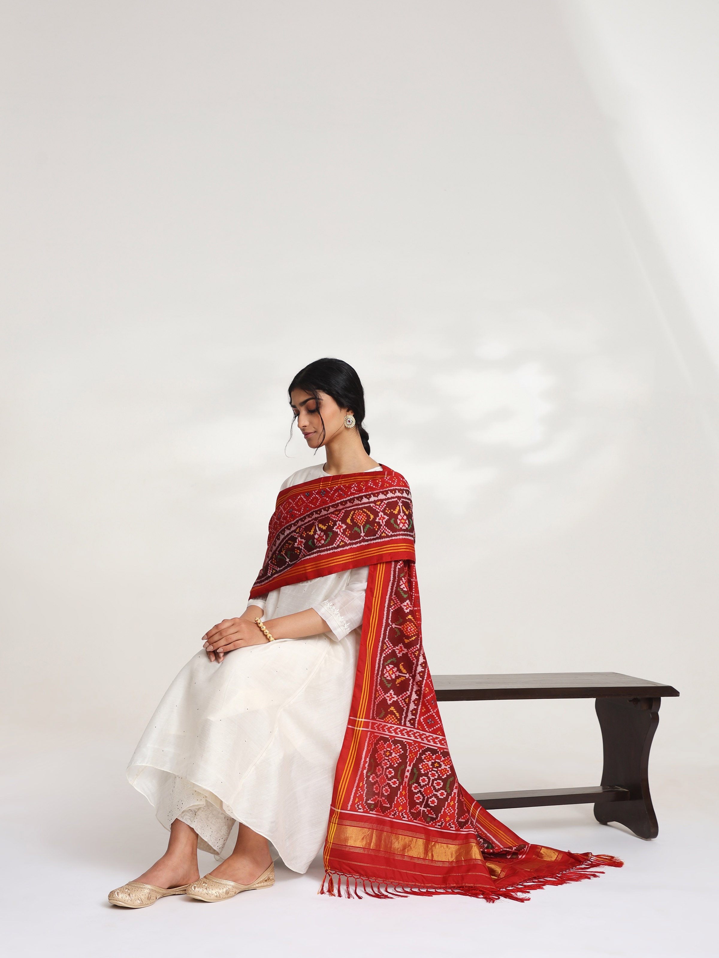 Side view of red silk semi ikat Patola dupatta highlighting silk texture