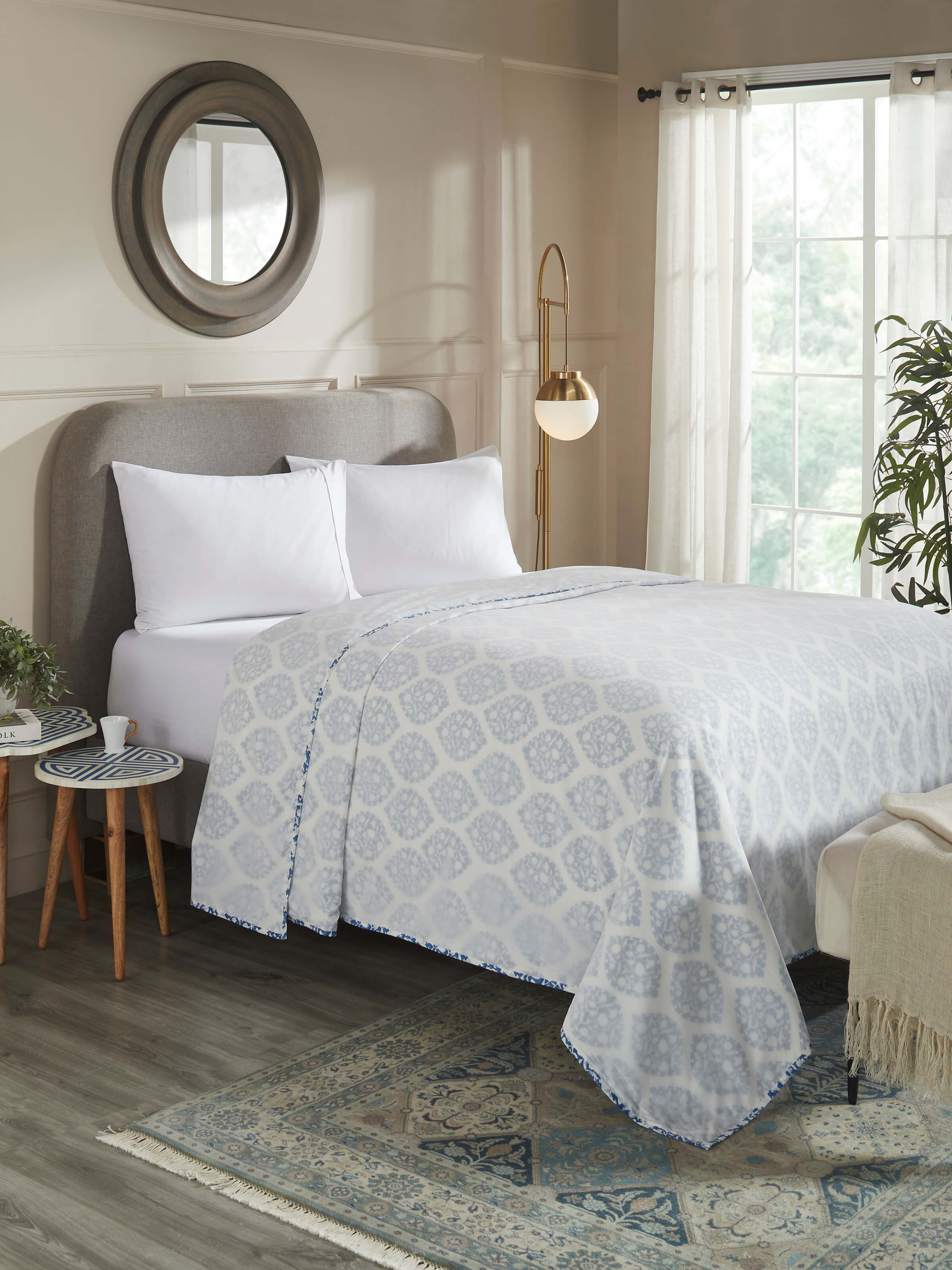 Lifestyle image of Mihrab dohar styled on a bed with soft blue and white pattern