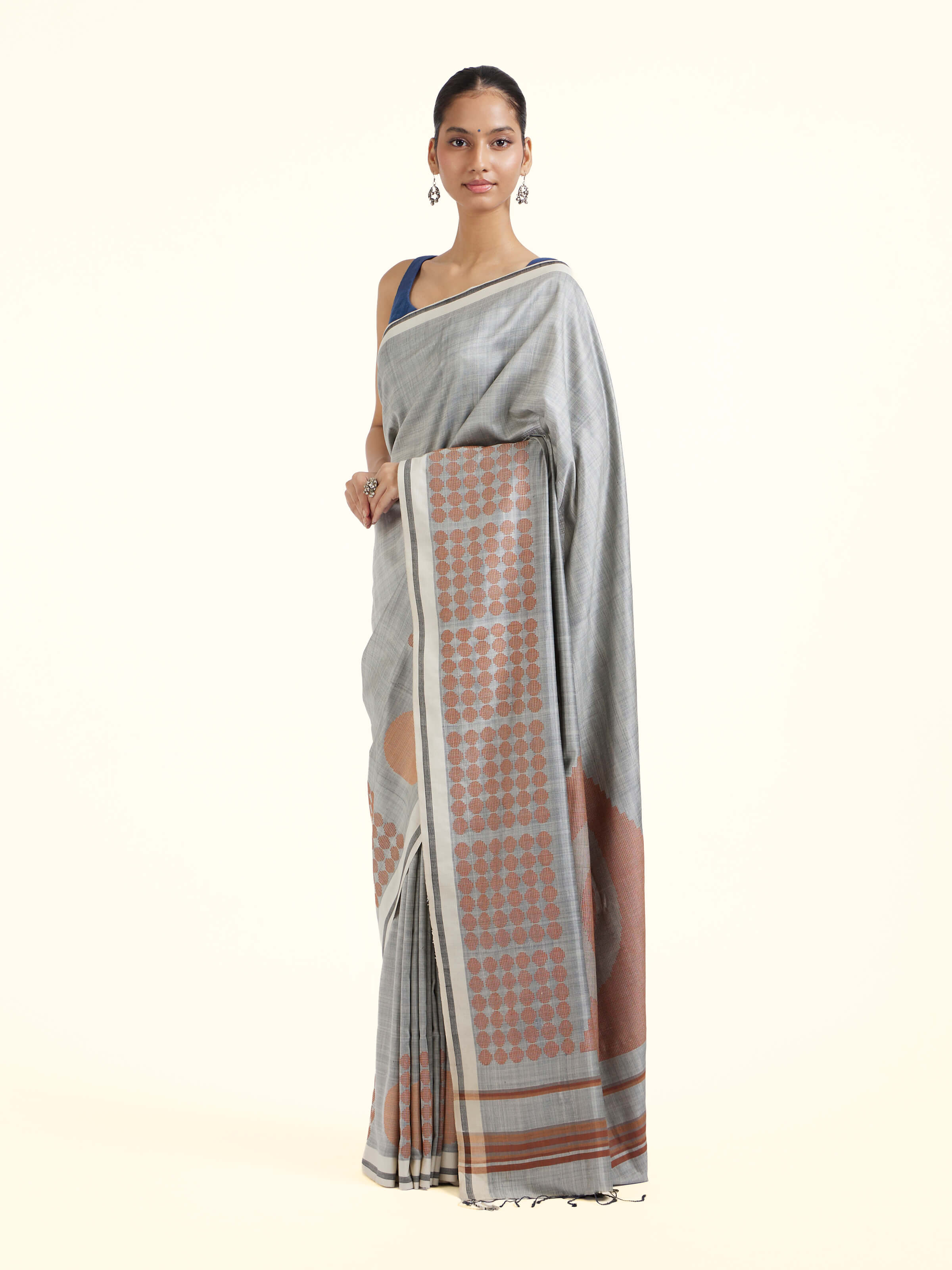 Side view of grey silk extra-weft saree highlighting graceful drape
