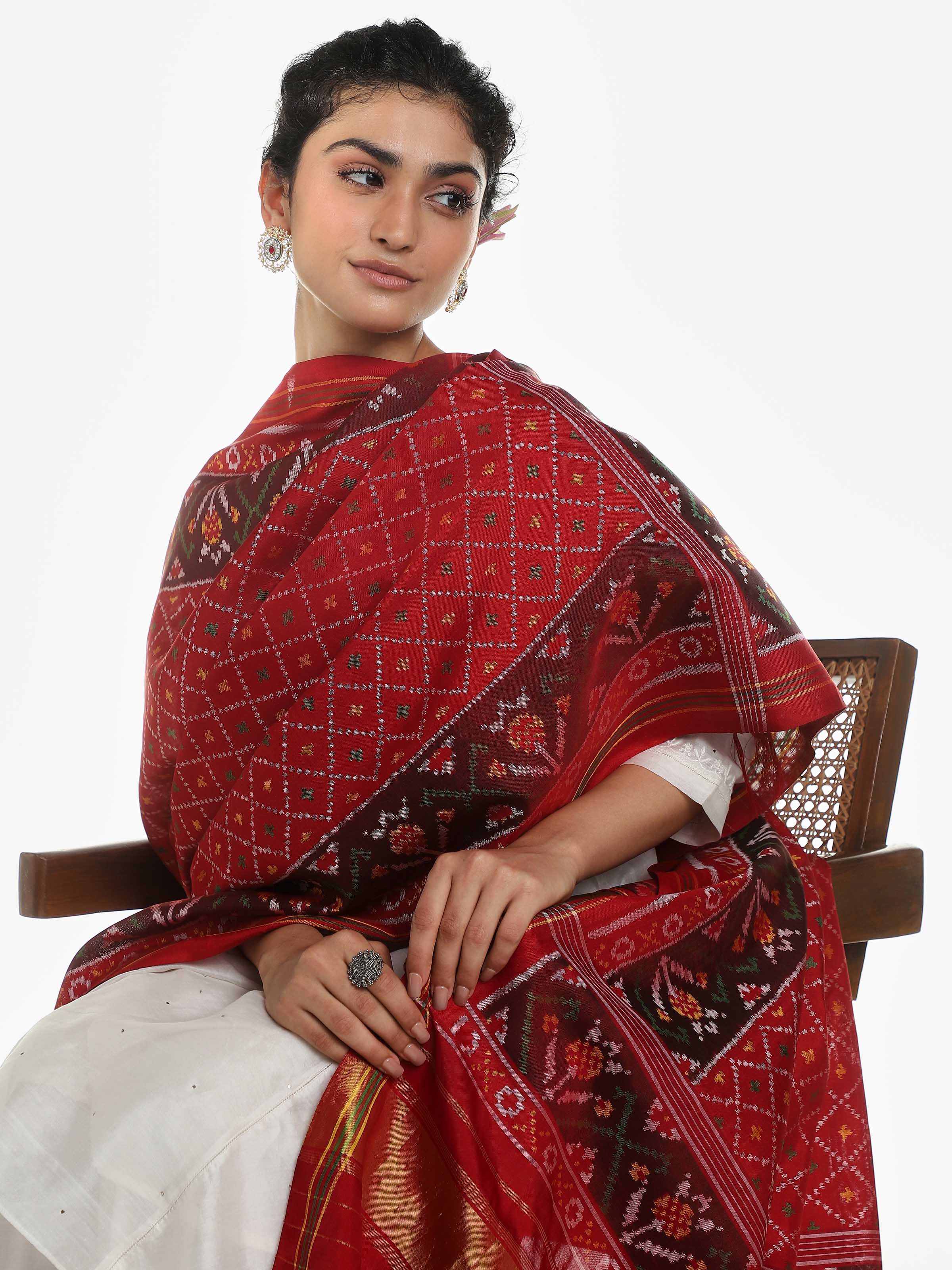 Side view of red silk Patola dupatta with detailed border and motifs