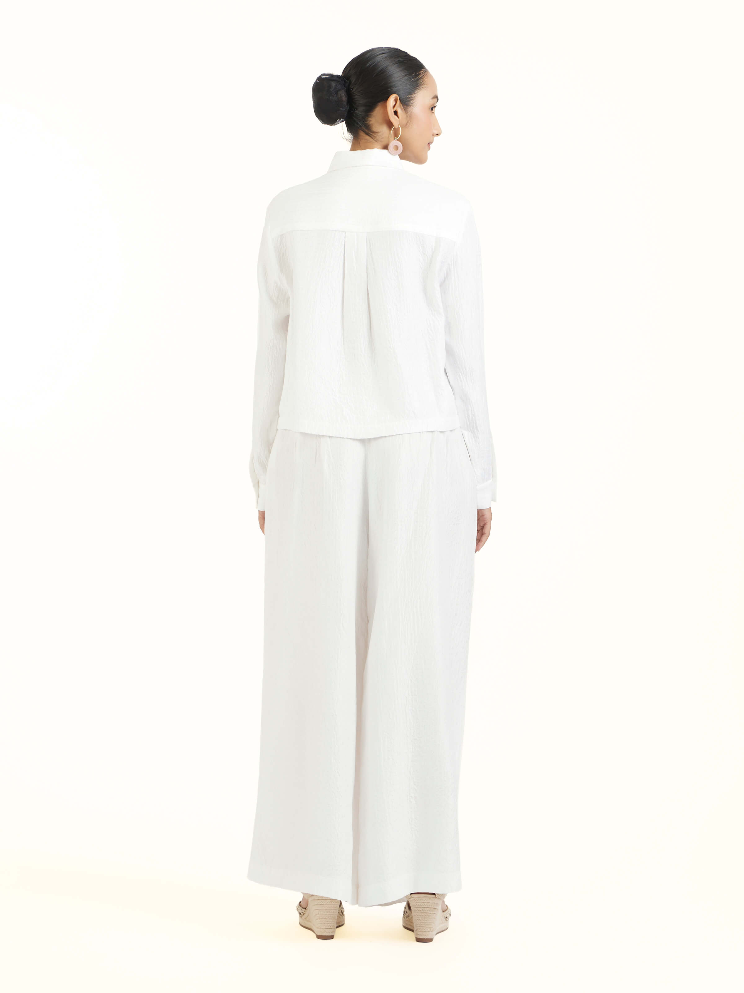 Back view of ivory quilted silk shirt displaying clean finish