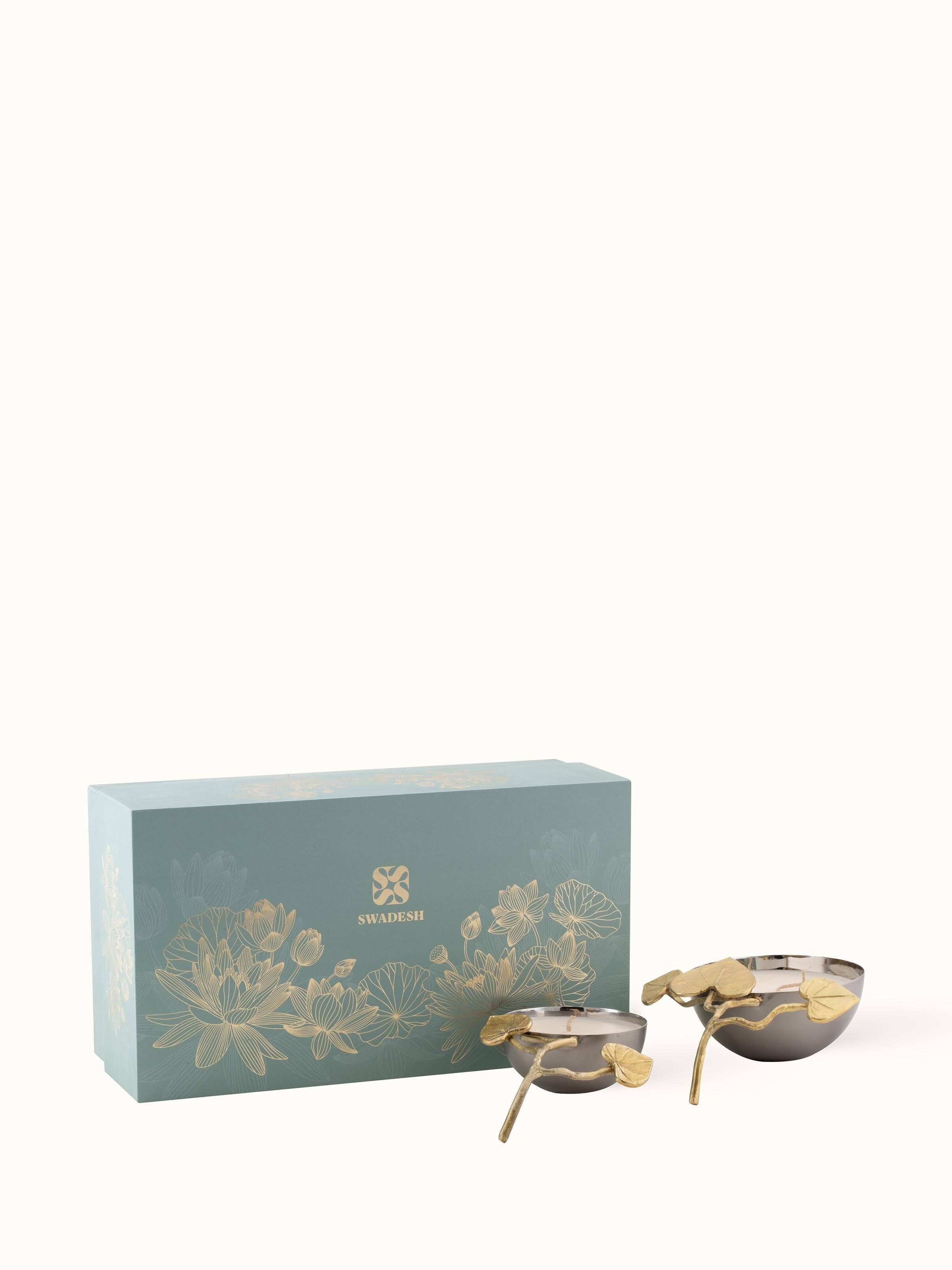 Angled view of Neroli brass candles (set of 2) focusing on their elegant shapes and overall design.