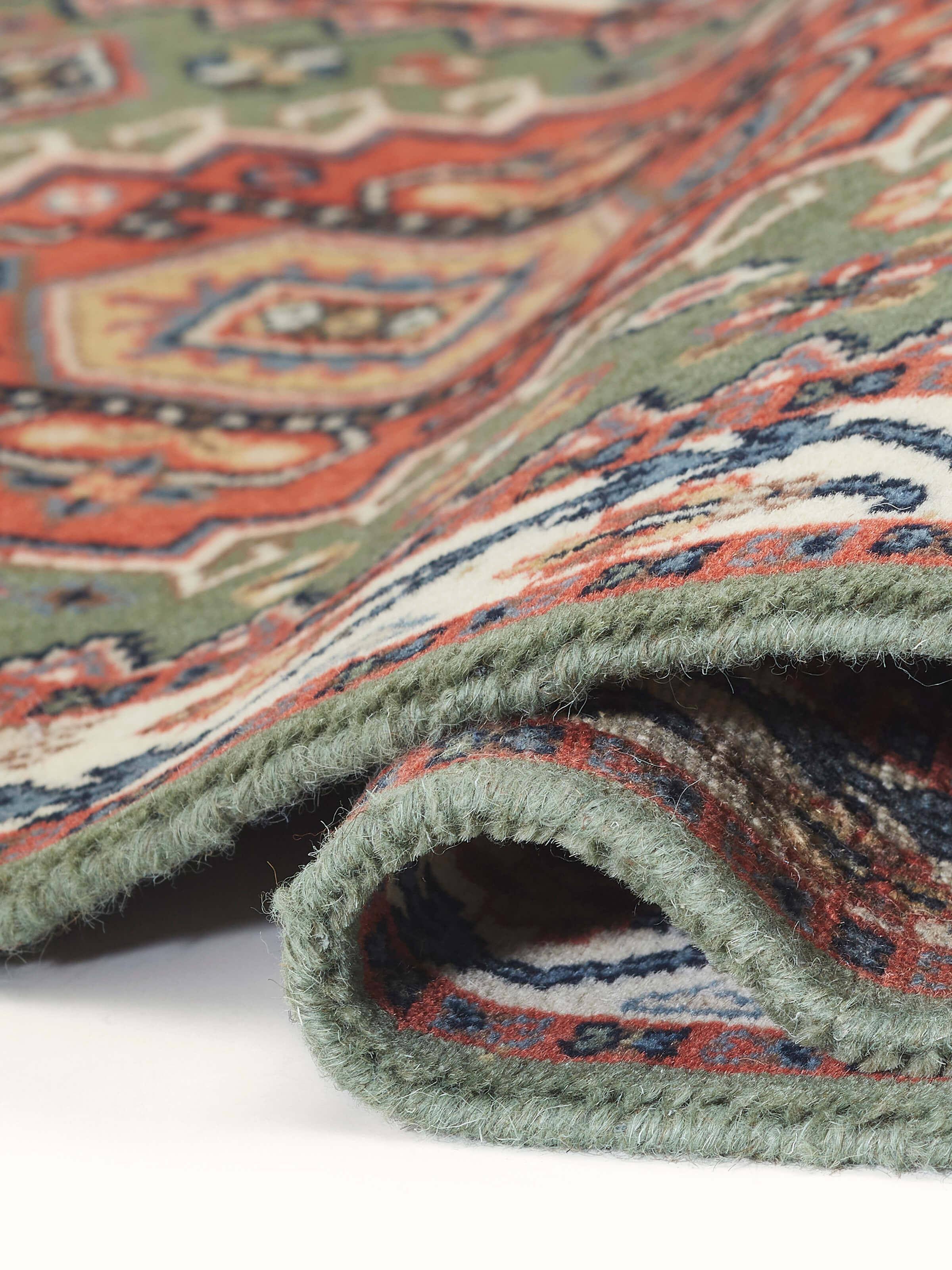 Side view of Persian Kazak light green Gwalior wool hand-knotted runner, illustrating its thickness and edge details