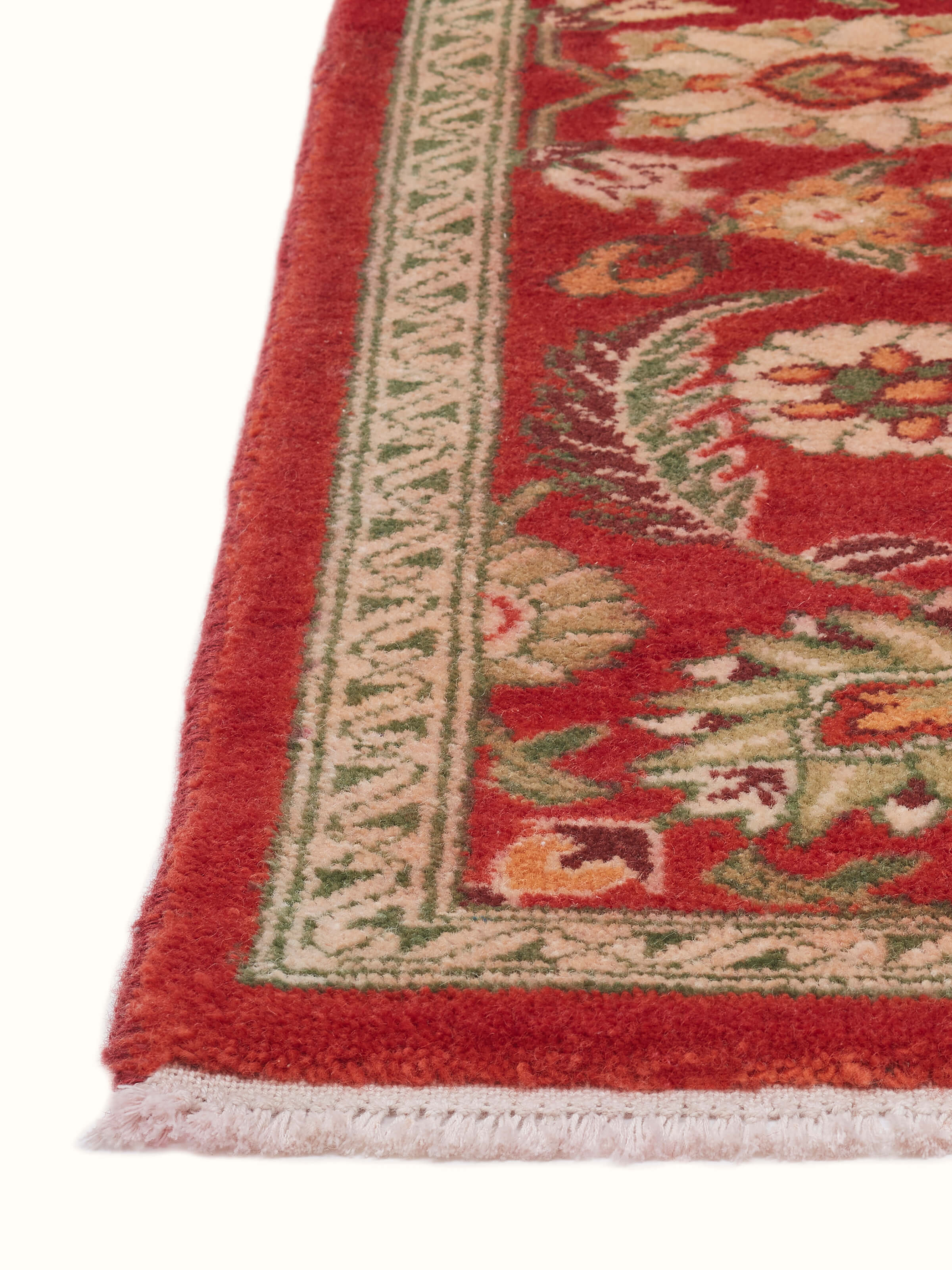 Angled view of Traditional Hand-knotted Red Agra Carpet highlighting rich patterns and craftsmanship
