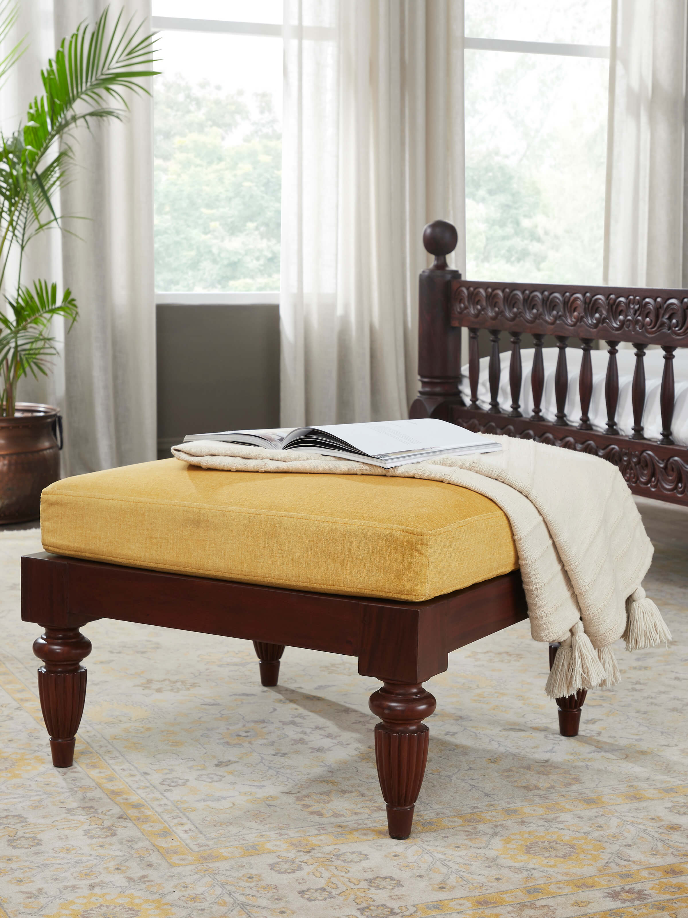 Side view of Upholstered Mahogany Wood Ottoman by Swadesh highlighting its elegant curves and premium upholstery.