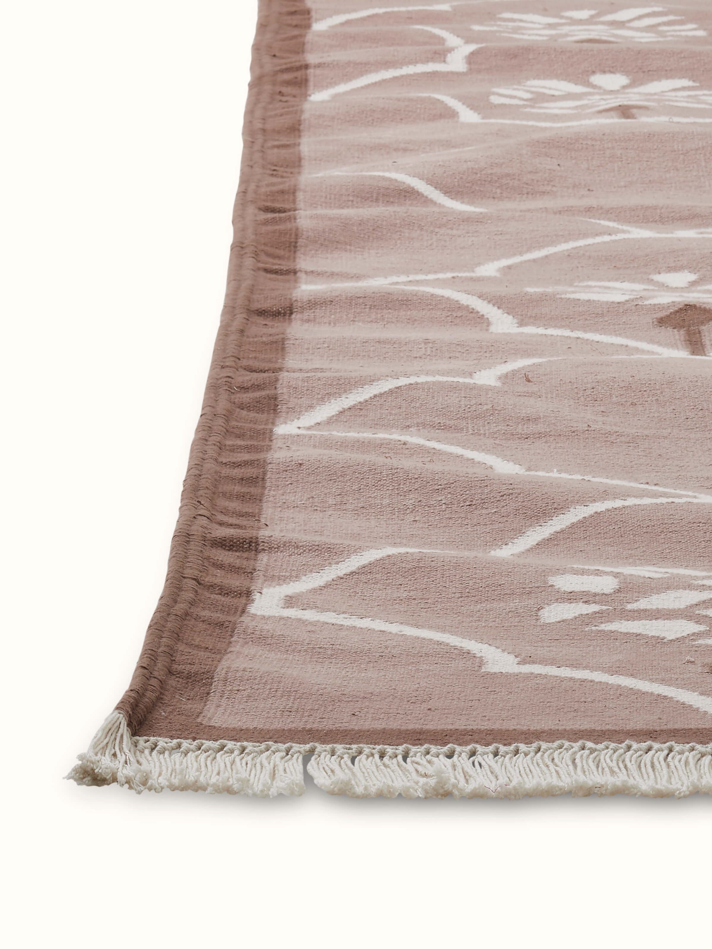 Detailed view of Stylised floral beige lawan cotton panja dhurrie showing the craftsmanship of the floral pattern