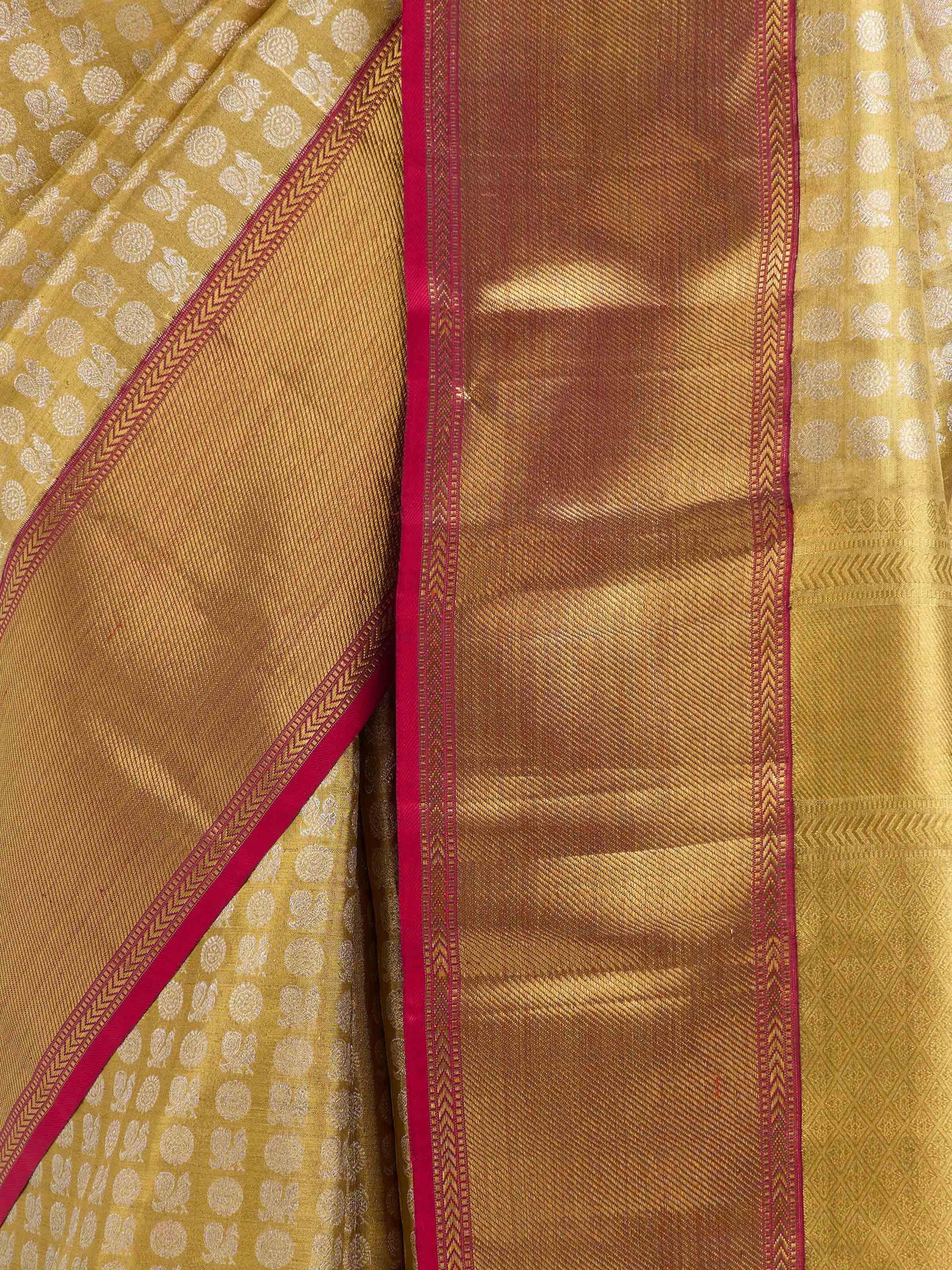 Detail view of gold silk Kancheepuram saree showing silk texture and zari weaving