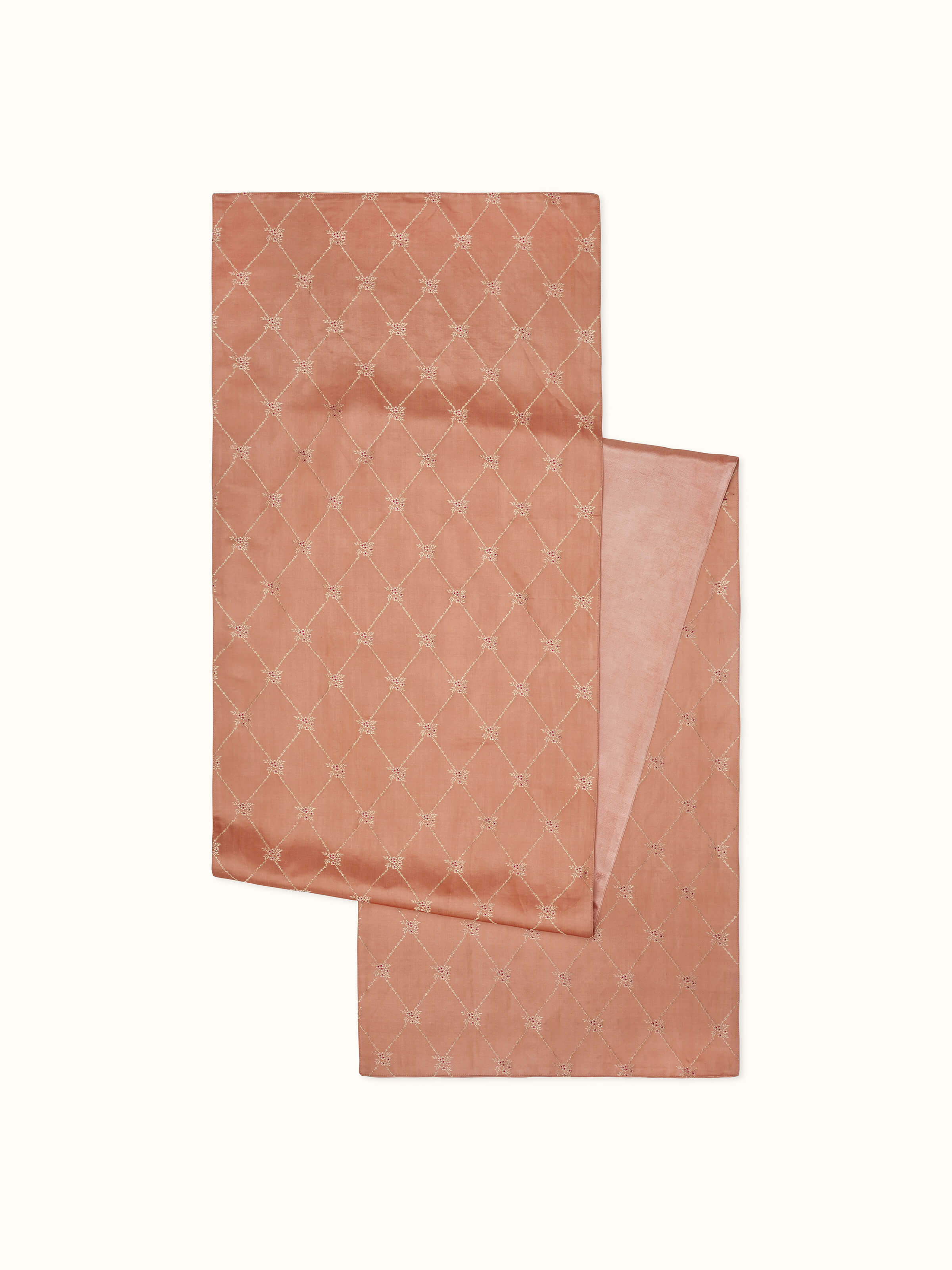 Detail shot of handwoven motifs and texture on the peach Banarasi silk bed runner.