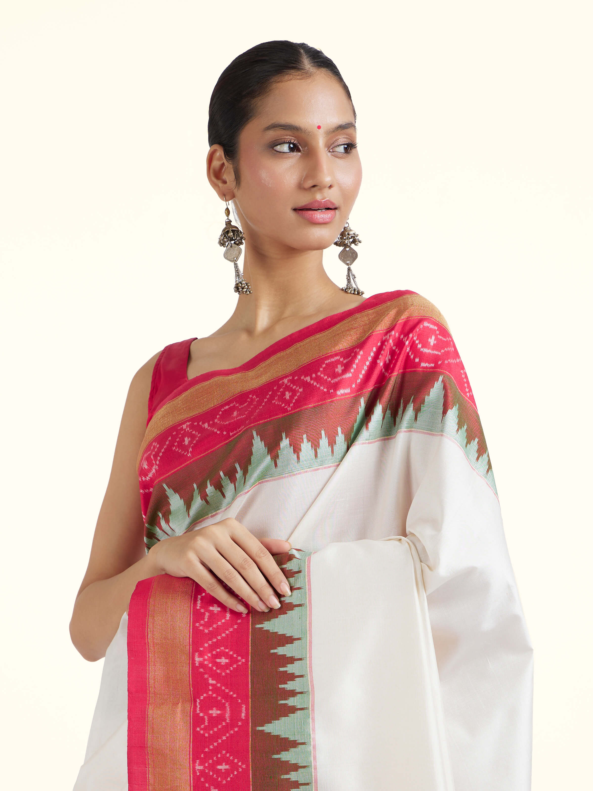 Angled view of off-white mulberry silk ikat saree showing overall design