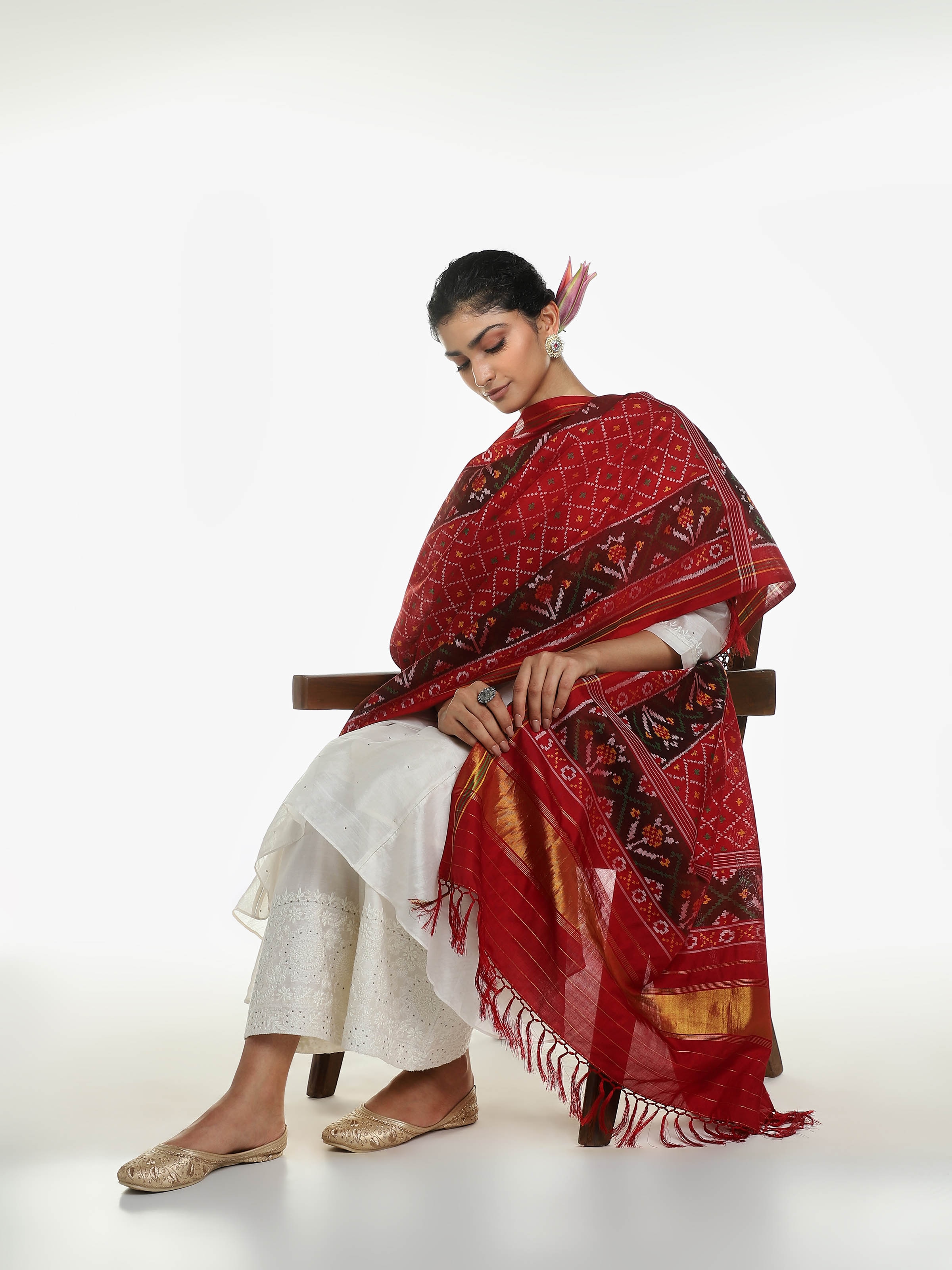 Side view of red silk Patola dupatta with intricate woven pattern