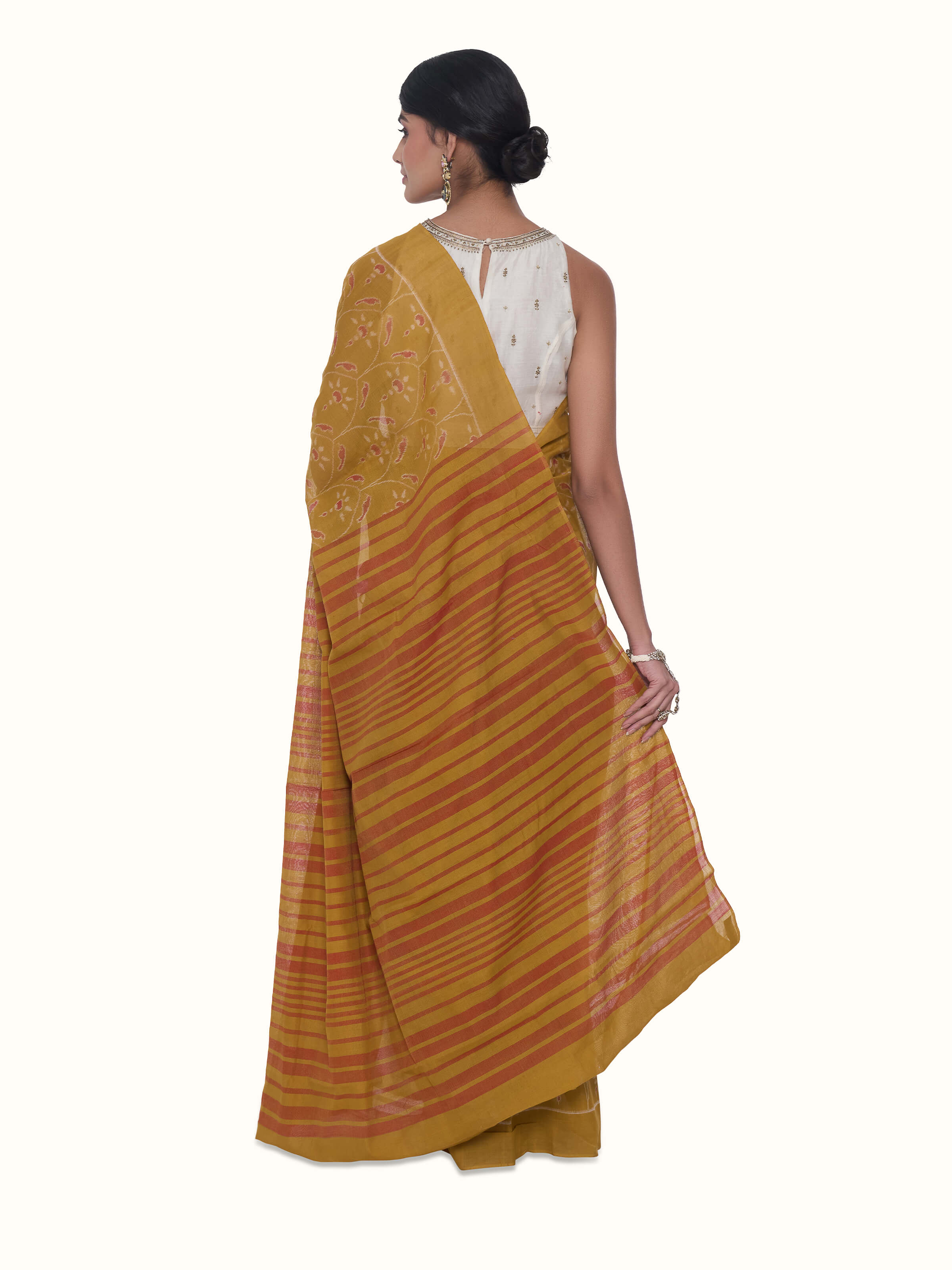 Back view of mustard cotton Odisha ikat bandha saree with coordinated pallu design