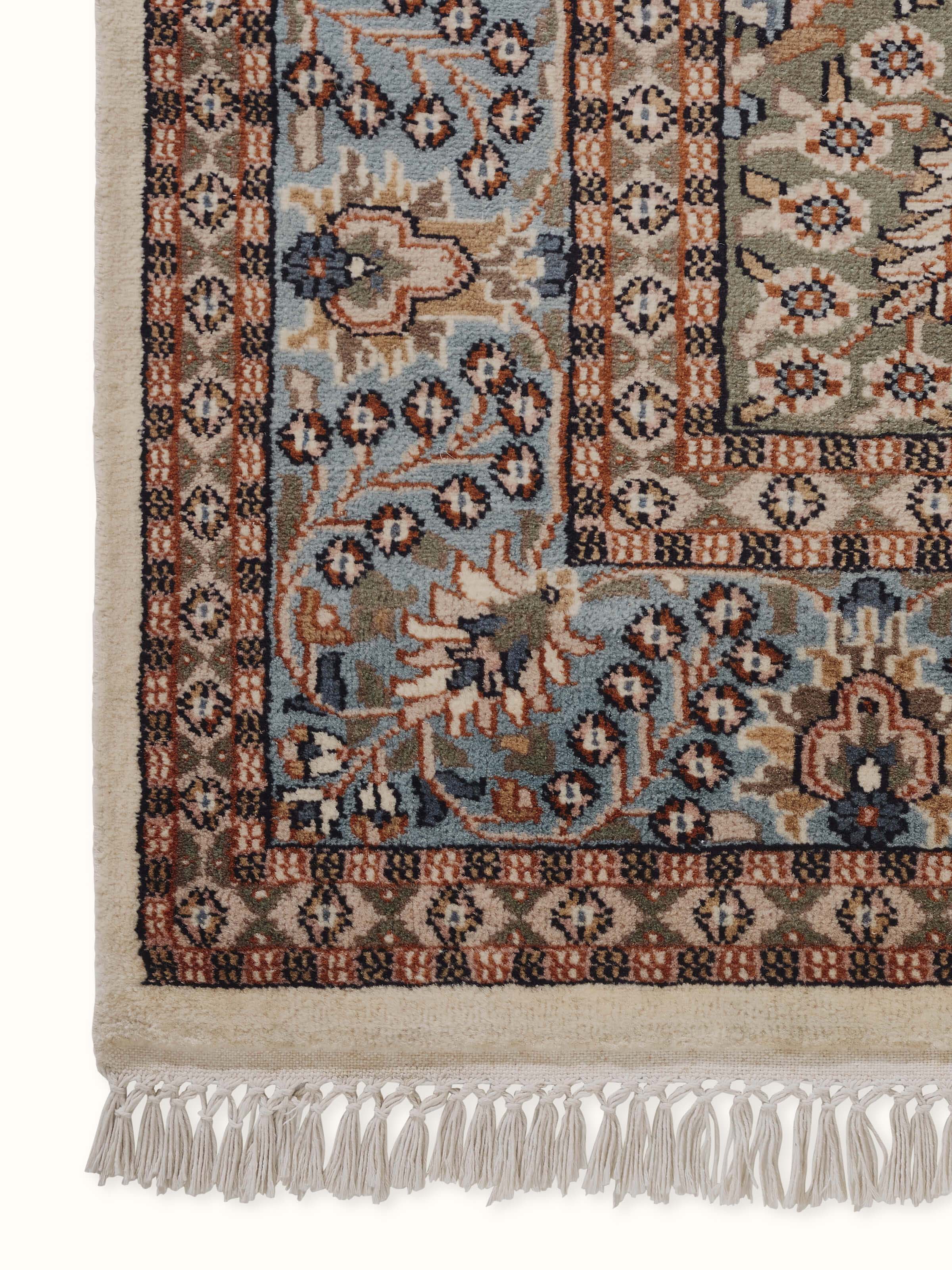 A close-up detail captures the medallion and floral vines, reflecting traditional artistry.