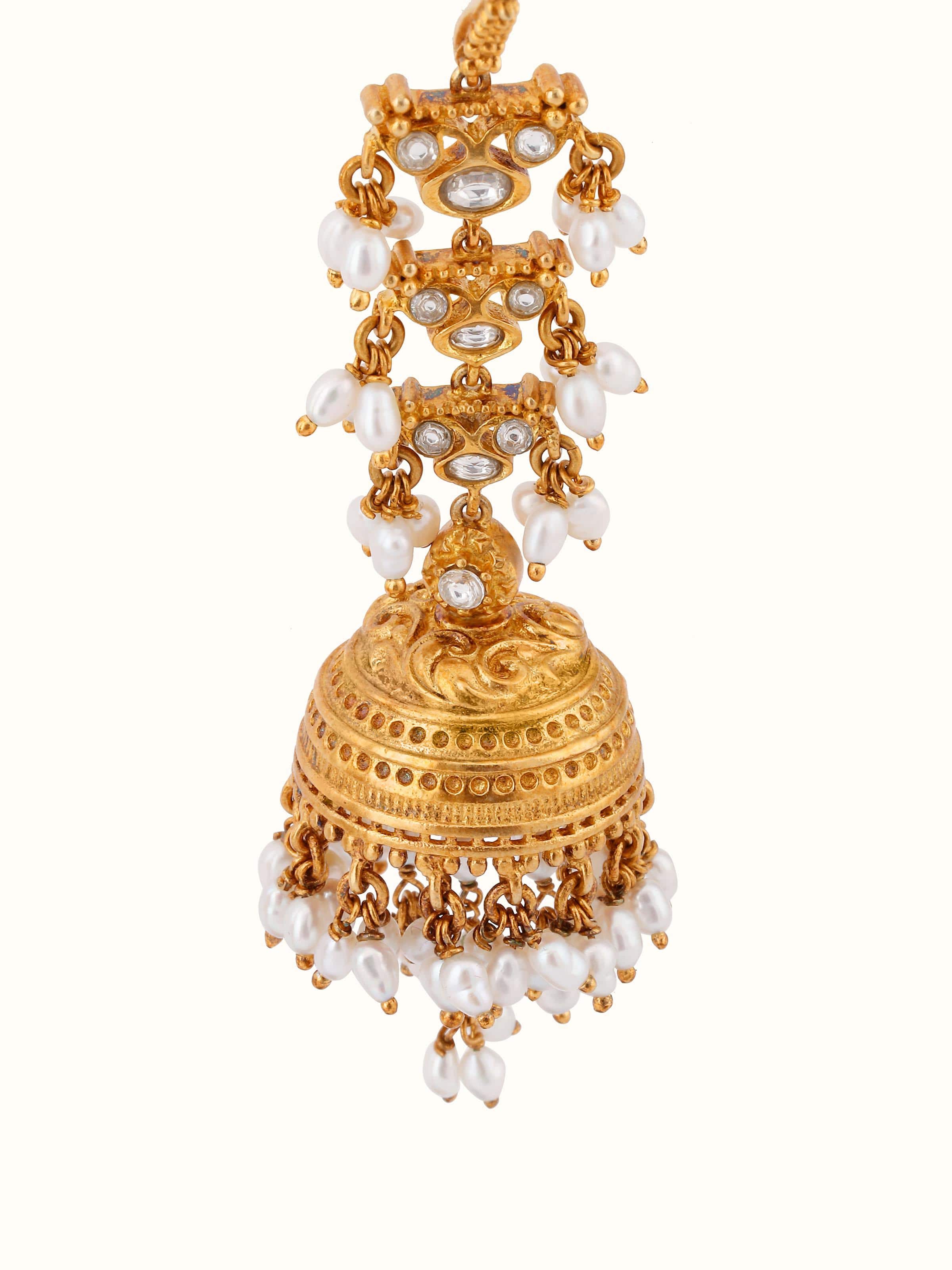 Overhead view of silver Guttapusalu jhumkas placed flat to show design symmetry.