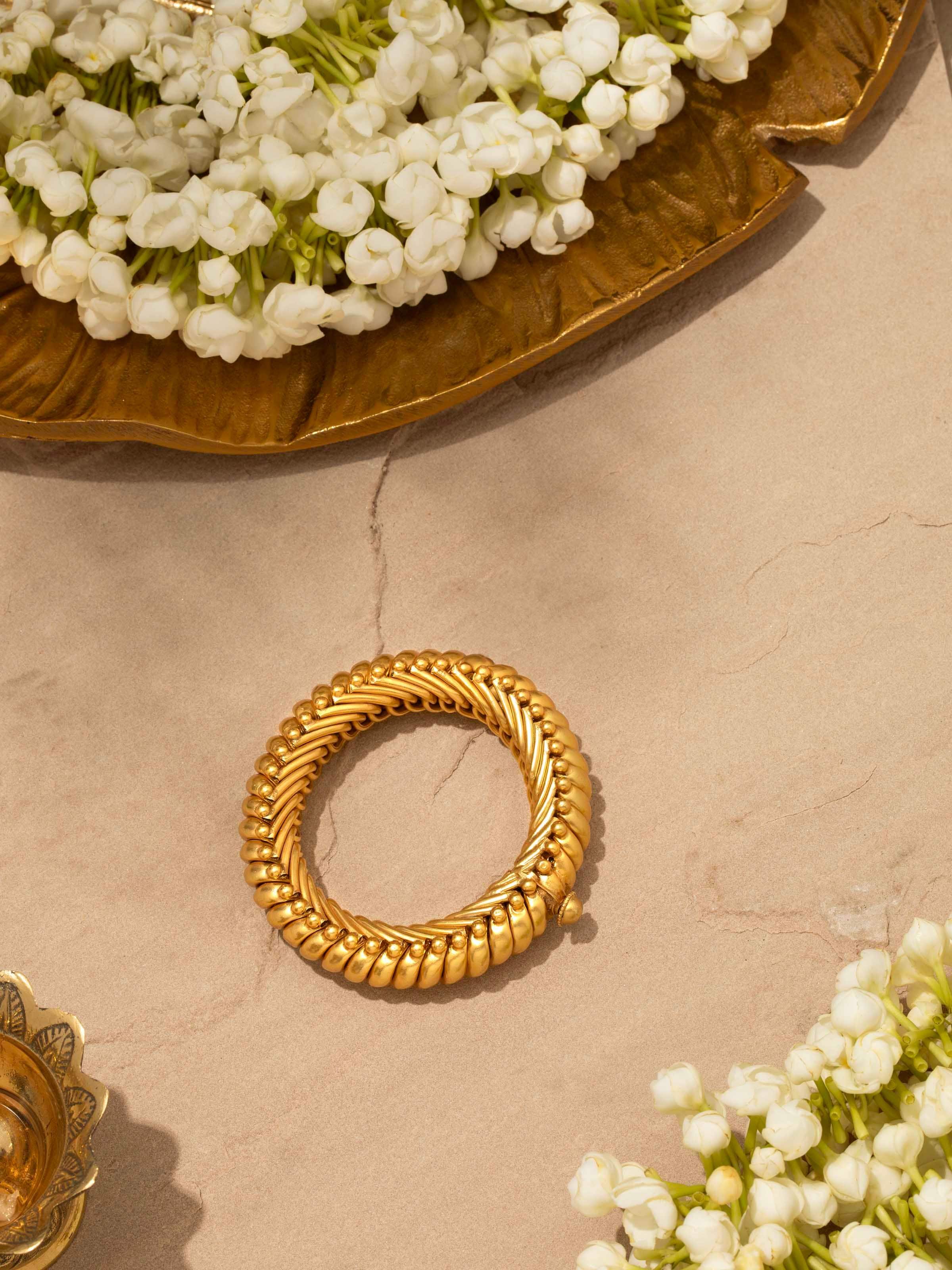 Overhead view of Smithing Bangle showcasing the full design and metal detailing