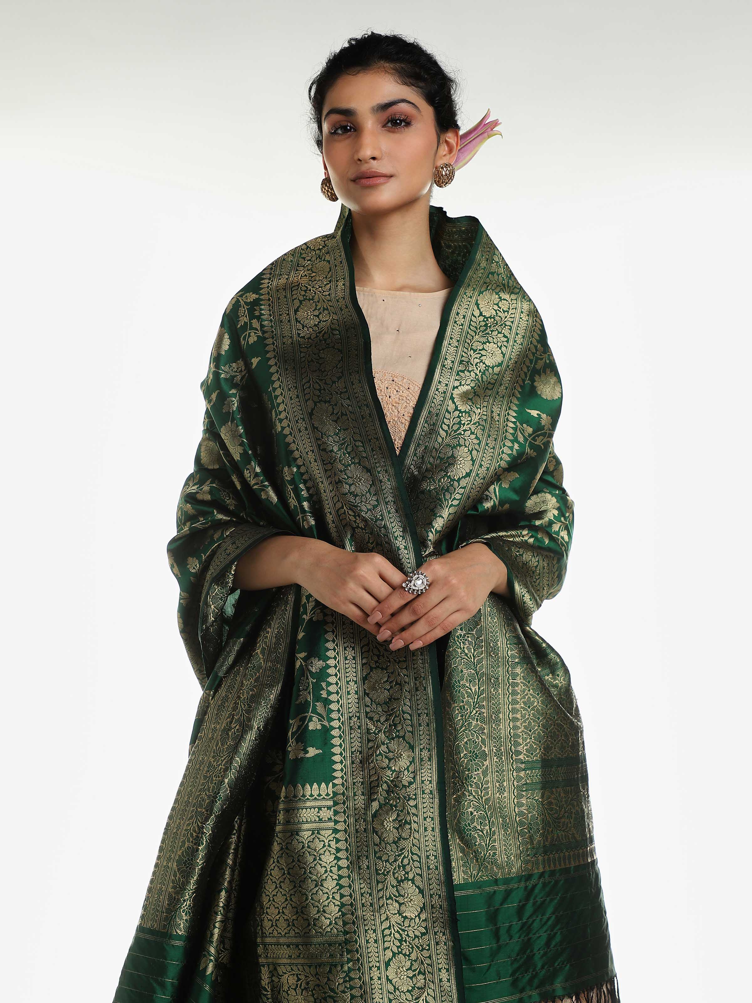 Angled view of dark green silk Banarasi dupatta showing full length design