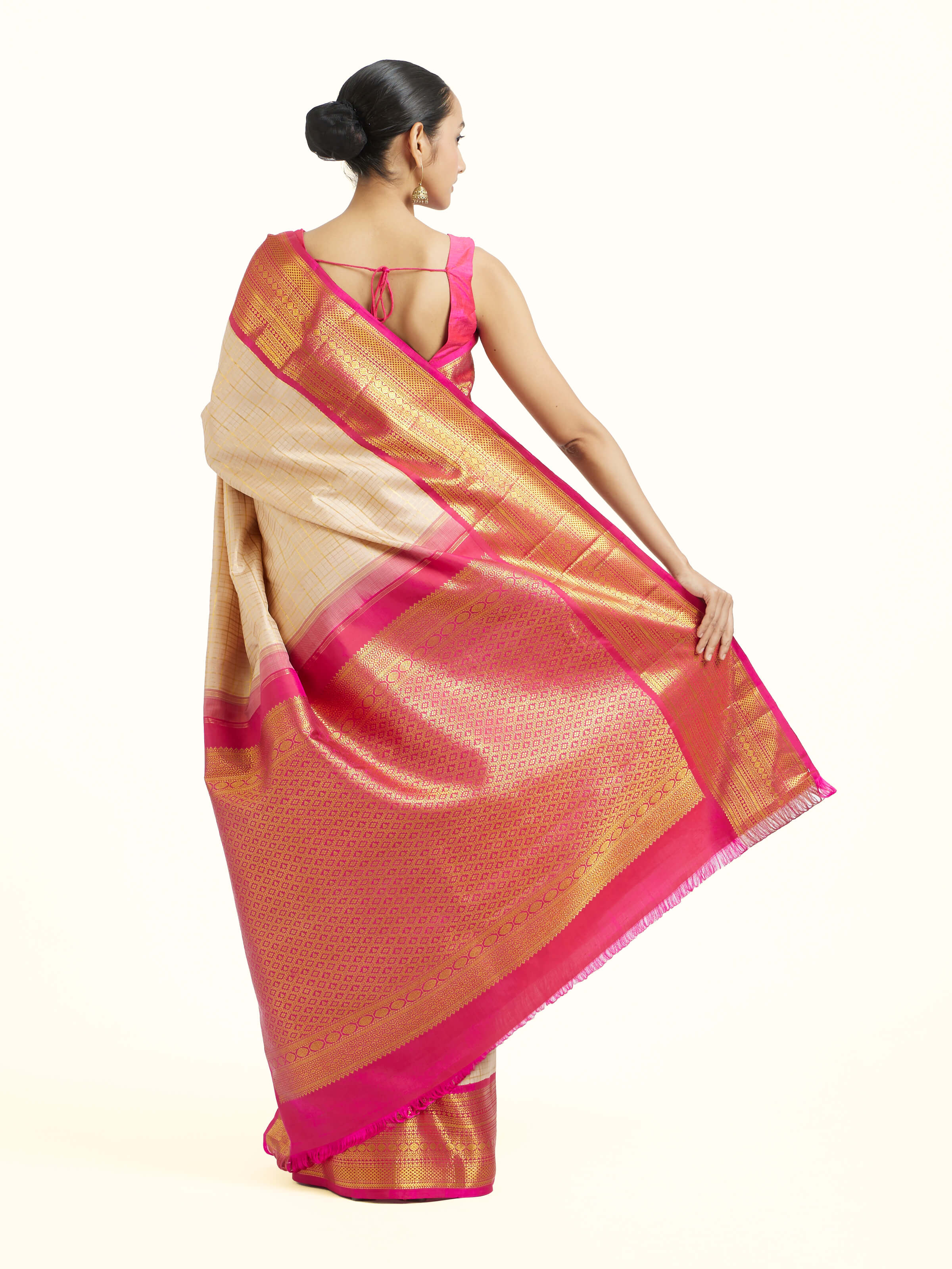 Back view of cream silk Kancheepuram saree displaying ornate pallu design