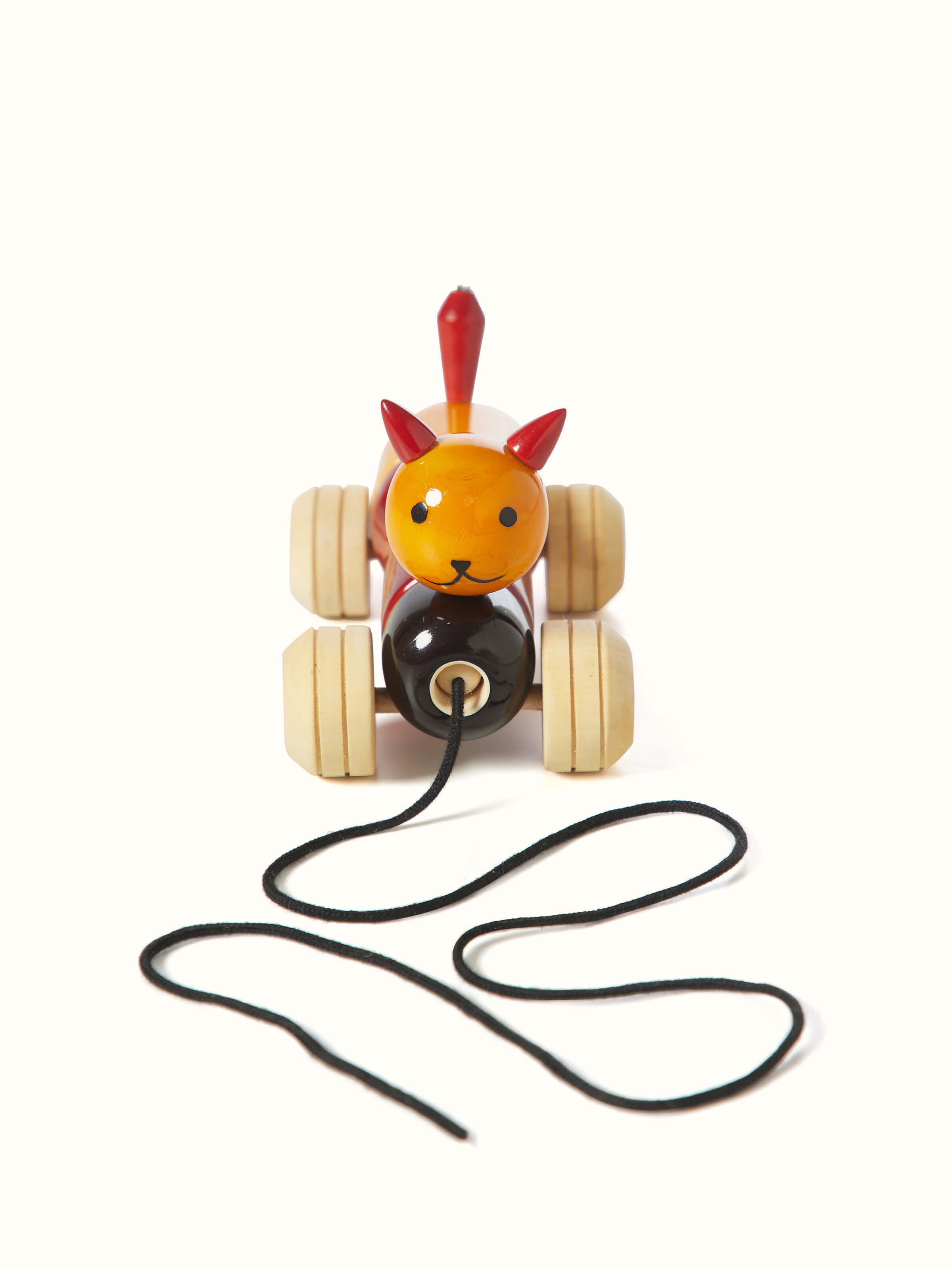 Channapatna ivory wood bovow yellow toy with a smooth finish and traditional design.