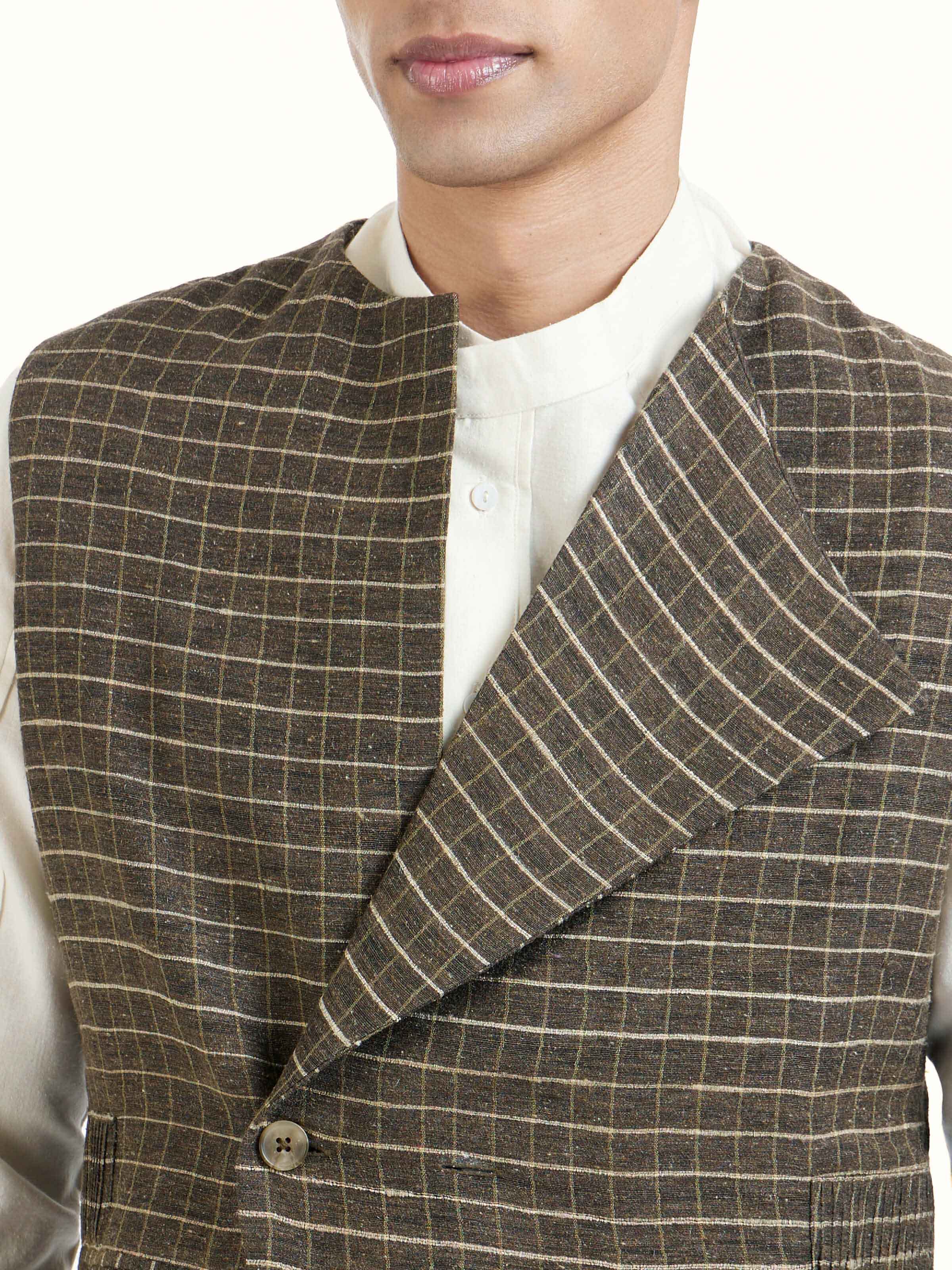 Detail view of brown handloom sleeveless jacket showing fabric texture and stitching details