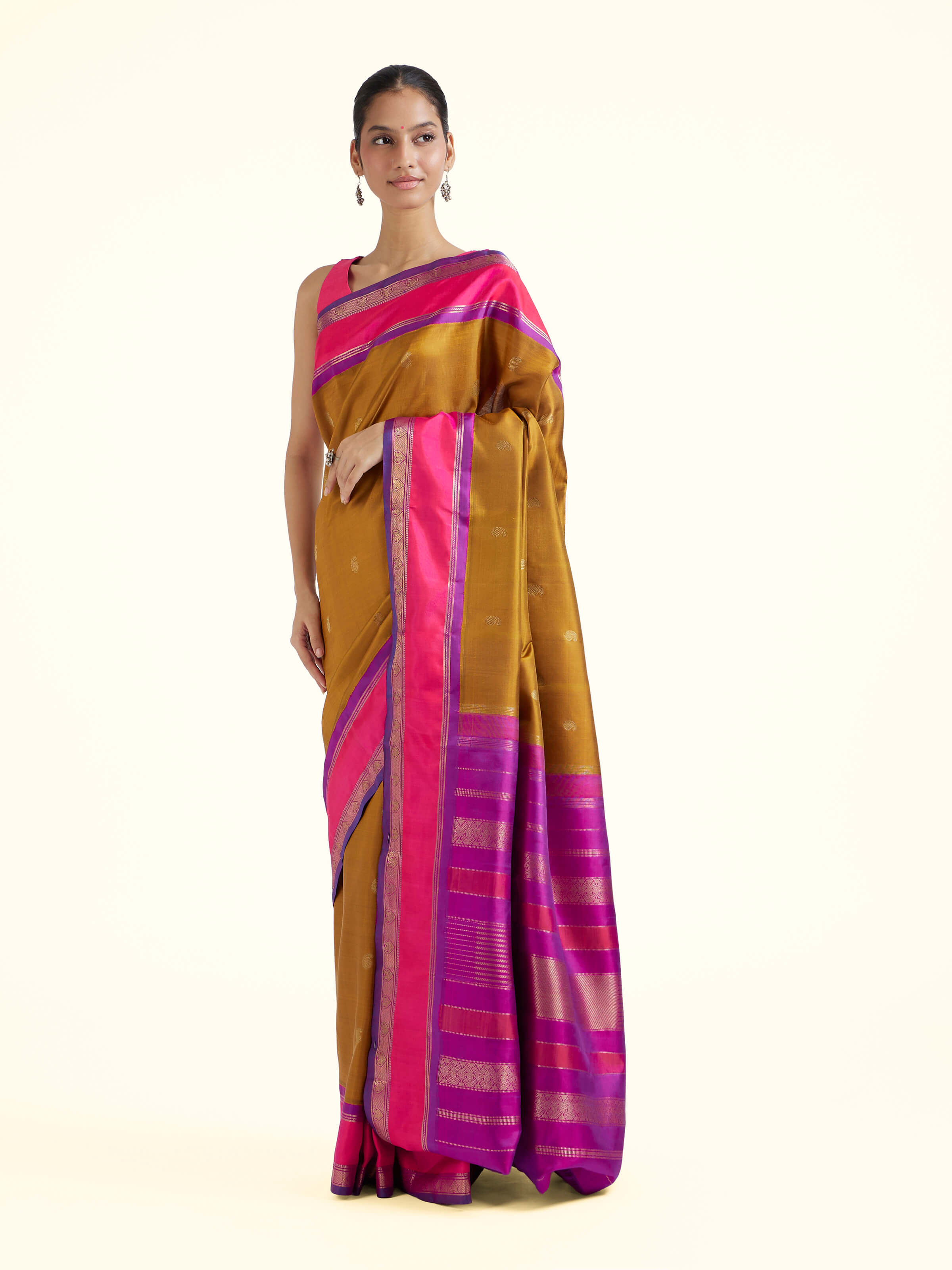 Side view of olive silk Kancheepuram saree with graceful drape and contrast border