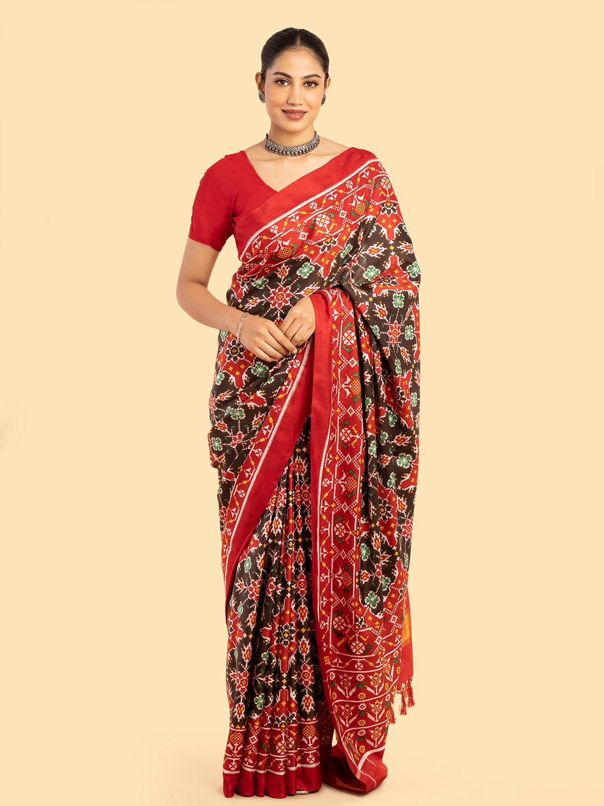 Side view of brown silk patola saree showing detailed weave and fabric sheen