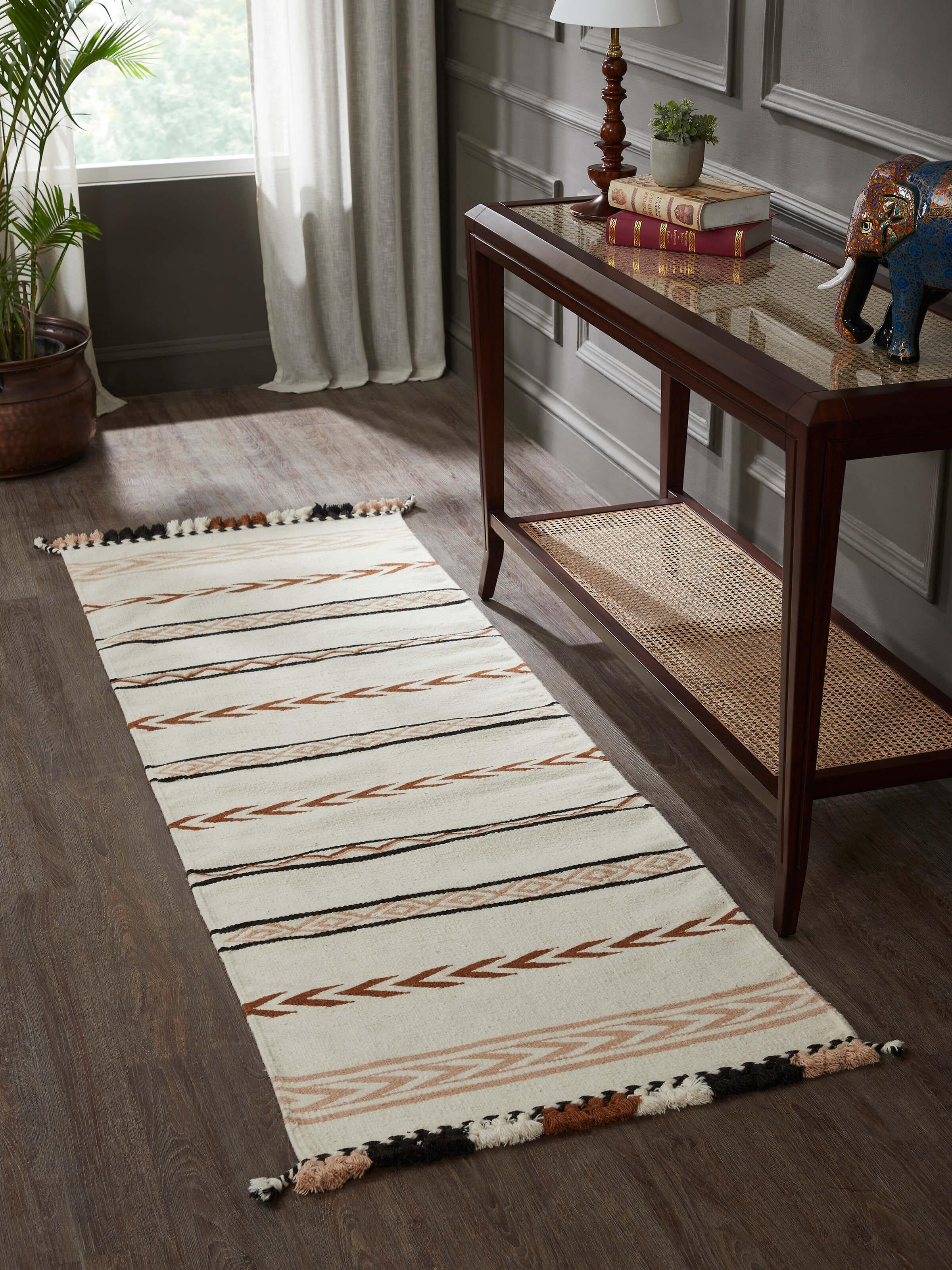 Lifestyle shot: Striped wool-cotton runner styled in corridor with artisanal Kharad weaving charm.