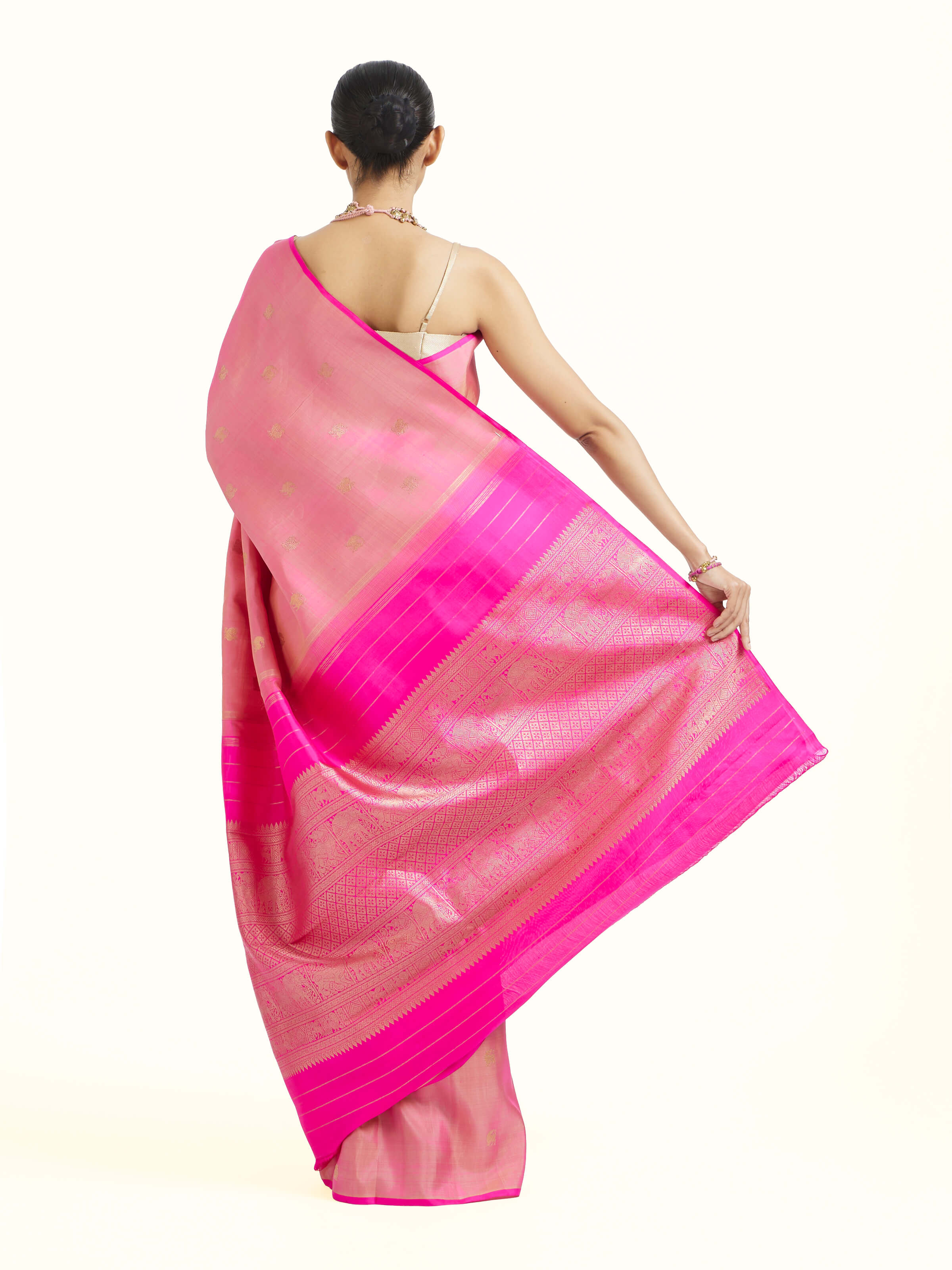 Back view of pink silk Kancheepuram saree displaying ornate pallu design