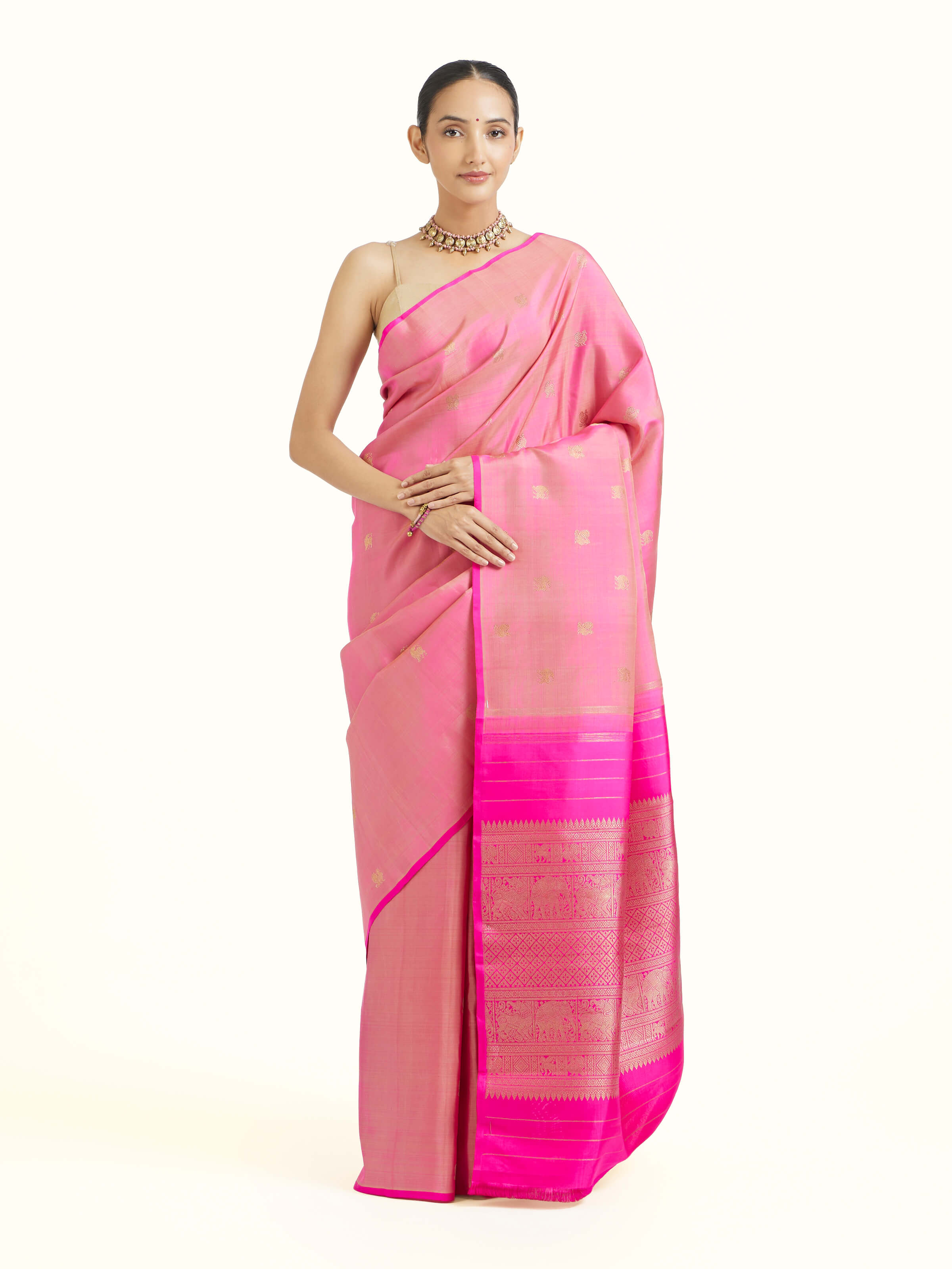 Front view of pink silk Kancheepuram saree with rich zari motifs