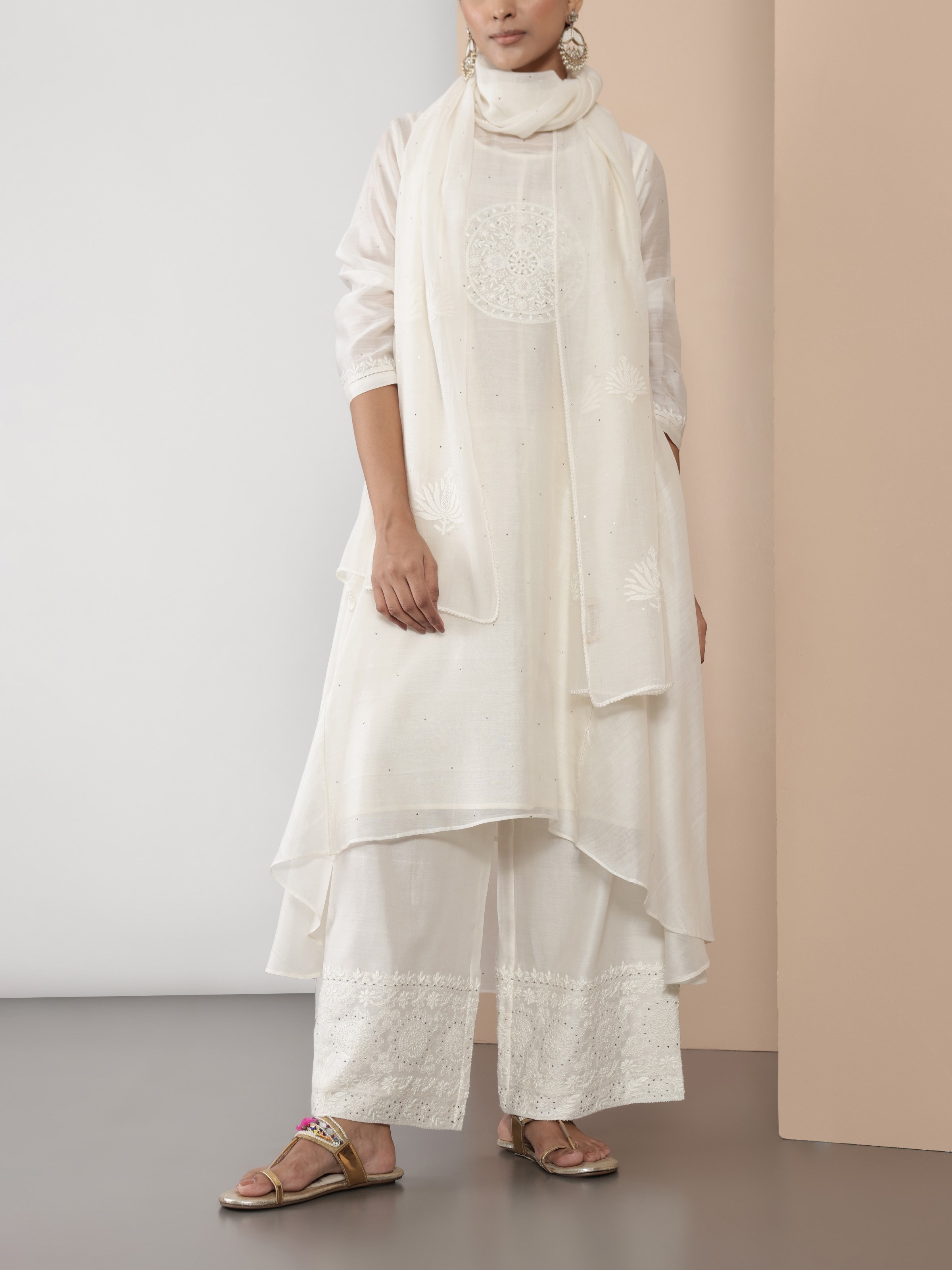 Lifestyle image capturing off-white Chikankari palazzo in motion, revealing airy texture and soft fall