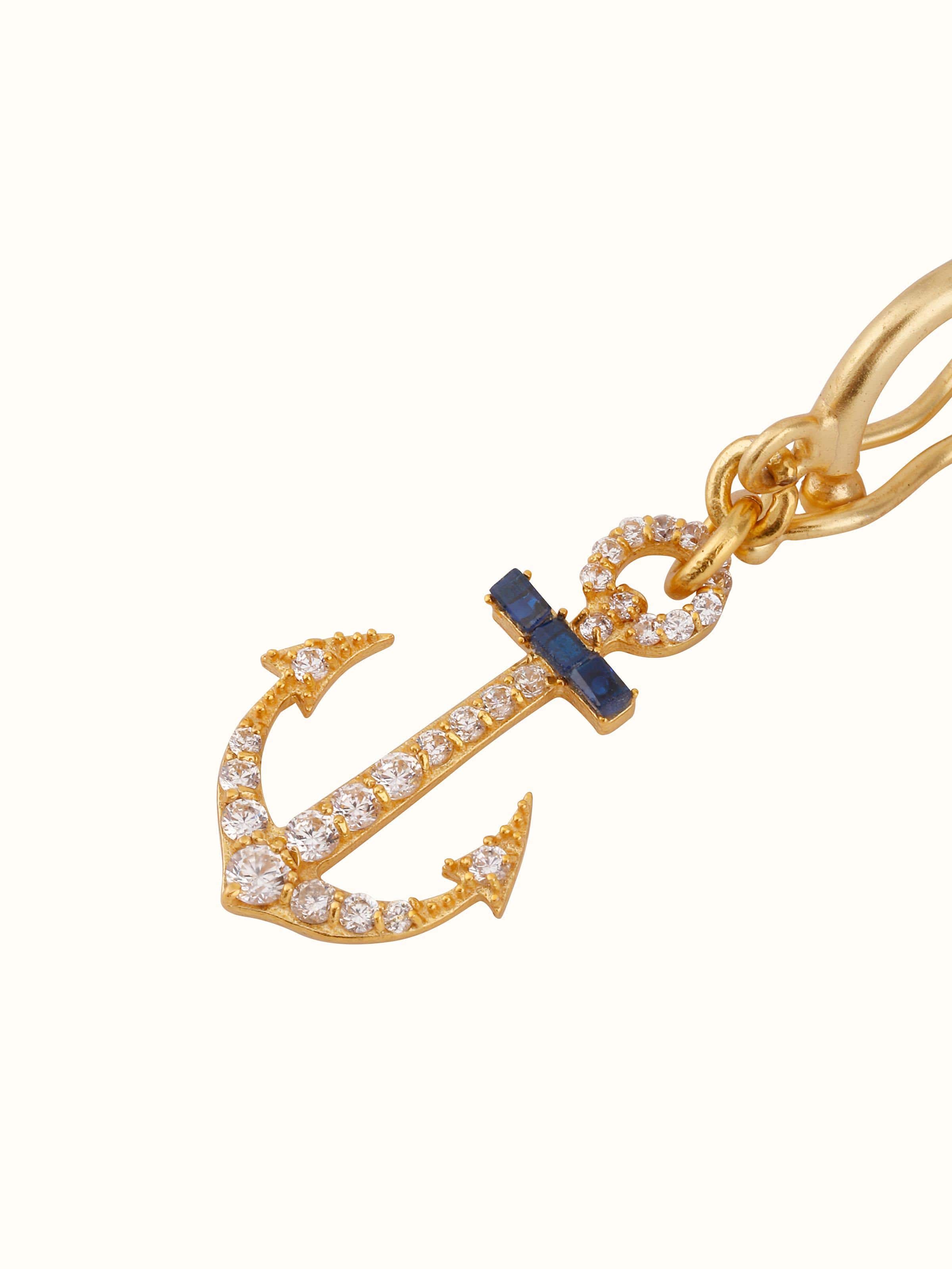 Overhead view of silver pendant displayed on plain backdrop, showcasing symmetrical form.