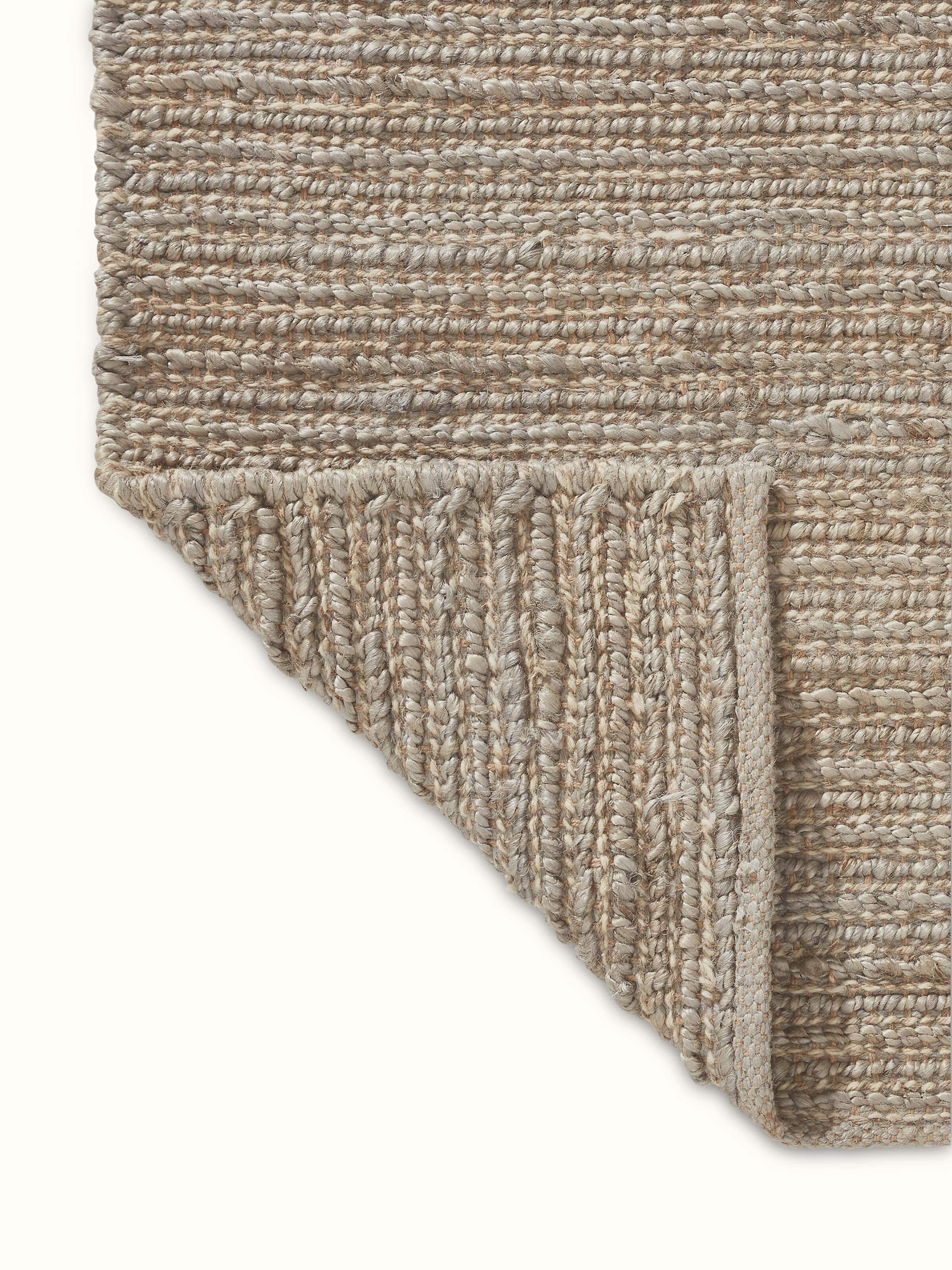 Back view of Solid Textured Grey Natural Fibre Rug with neatly finished edges and backing structure