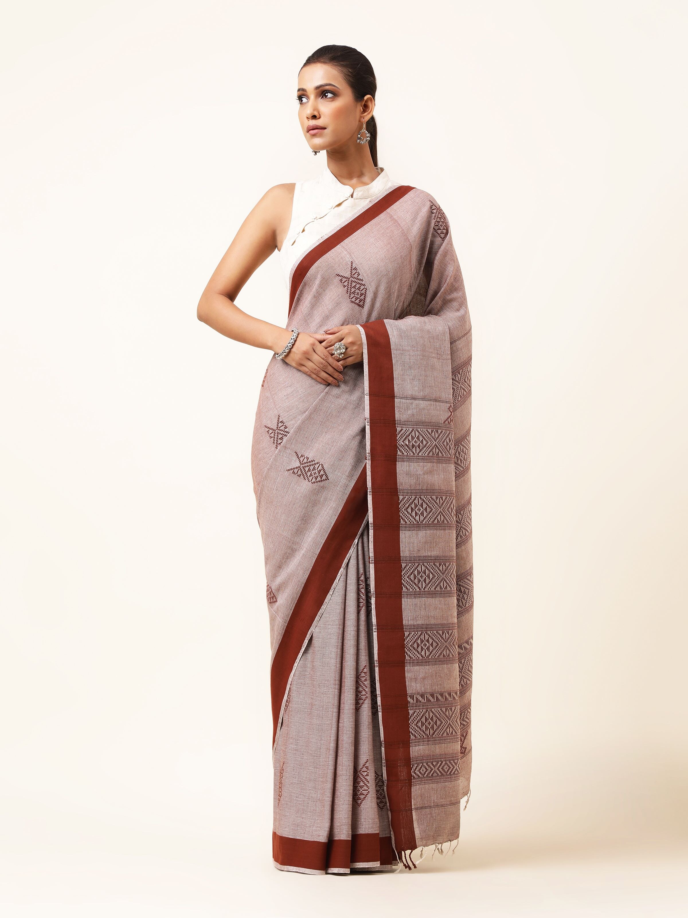 Front view of brown cotton saree with extra-weft woven design and artisanal finish
