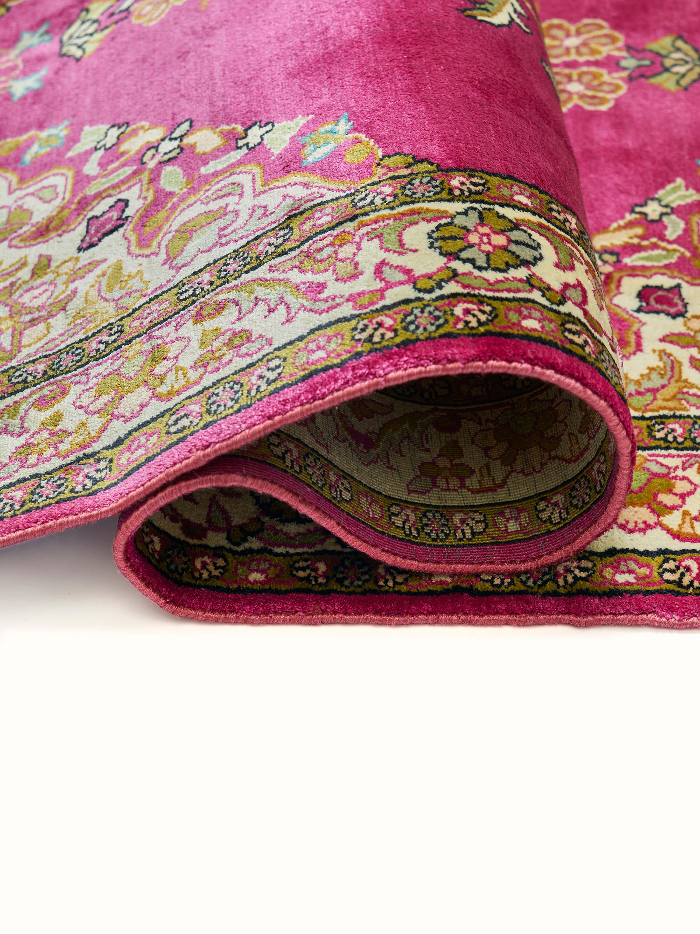 Close-up of floral pattern and fine silk weaving in Traditional Opan pink carpet