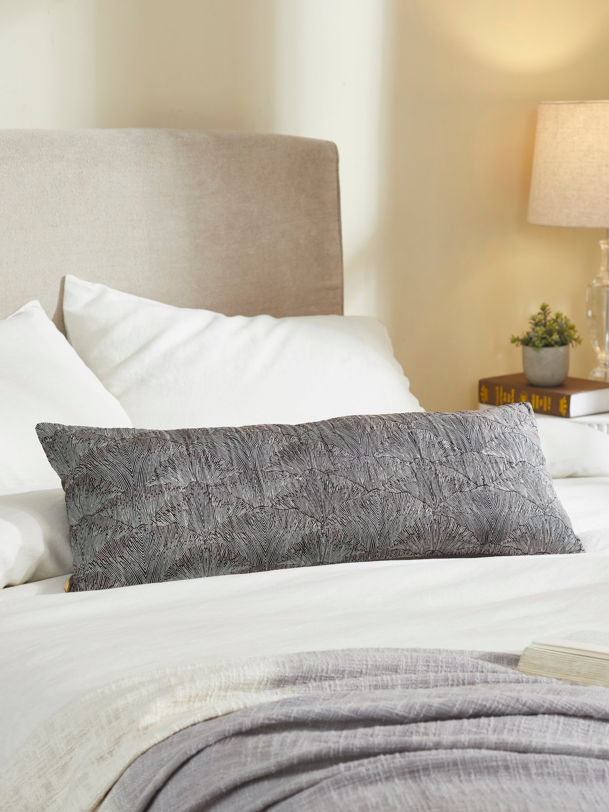 Parvat brown silk cushion cover with leaf motif styled on beige sofa