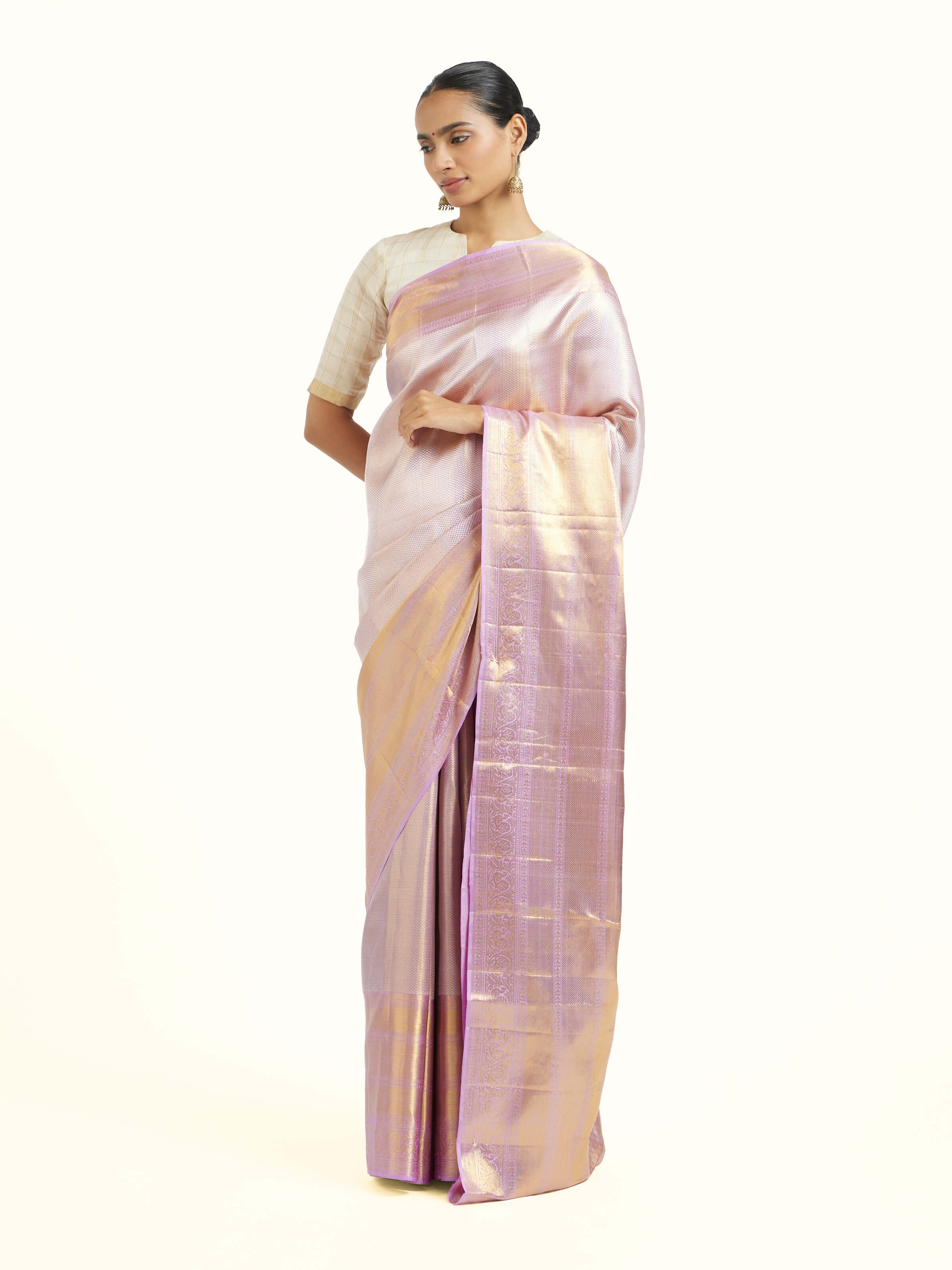Side view of beige silk Kancheepuram saree showcasing graceful drape