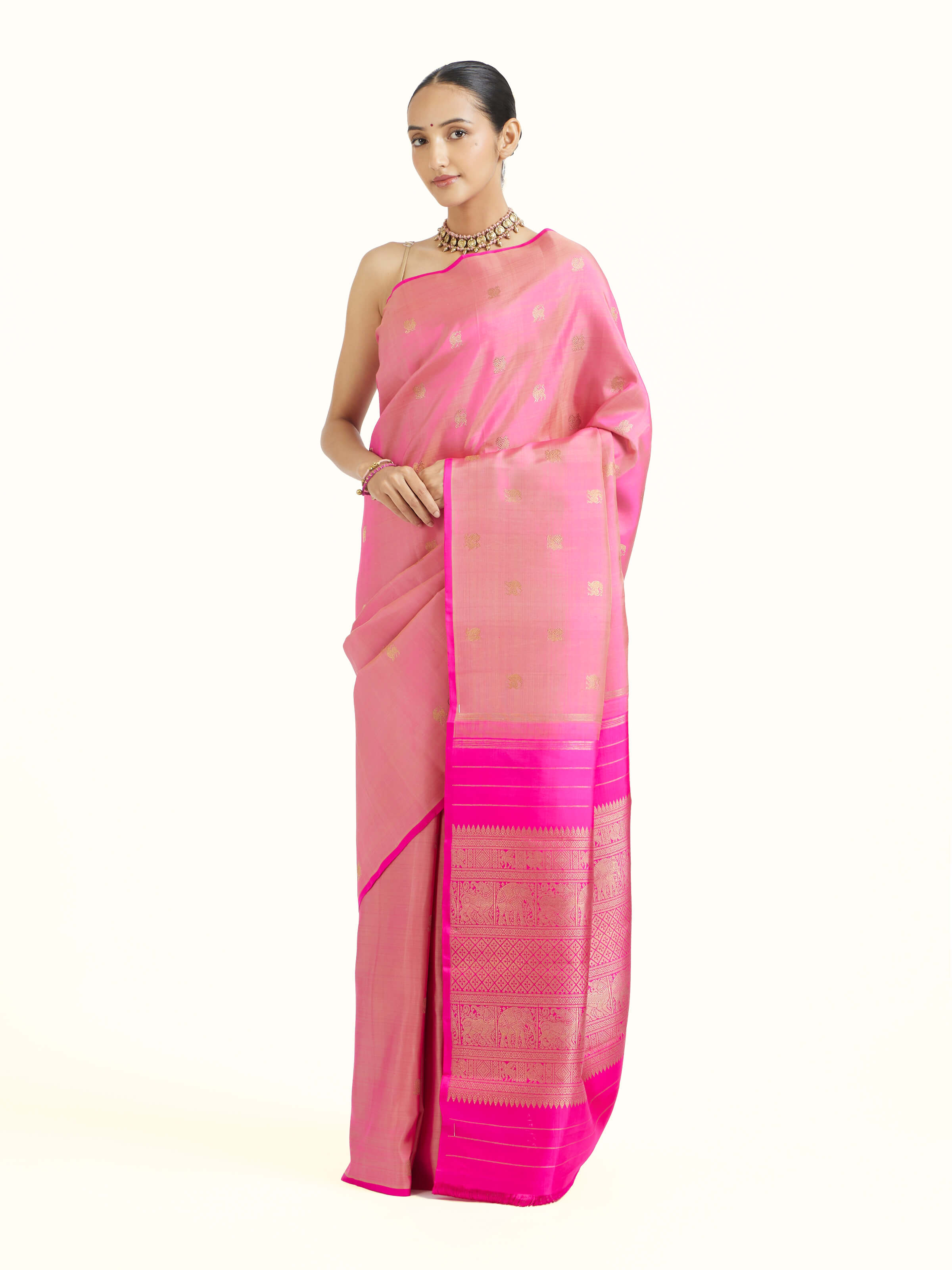 Side view of pink silk Kancheepuram saree highlighting drape and silk sheen