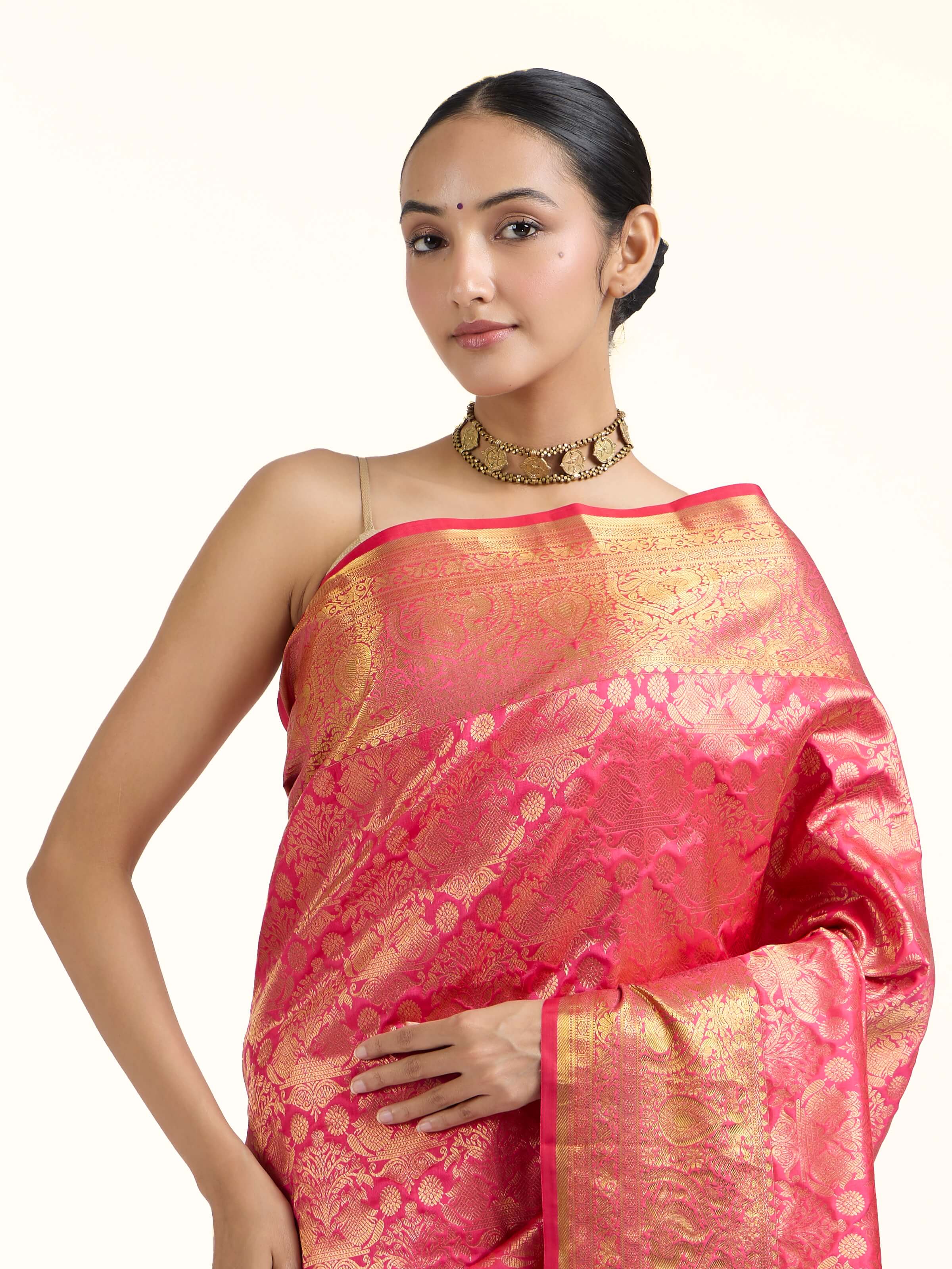 Angled view of red silk Kancheepuram saree highlighting traditional weaving technique