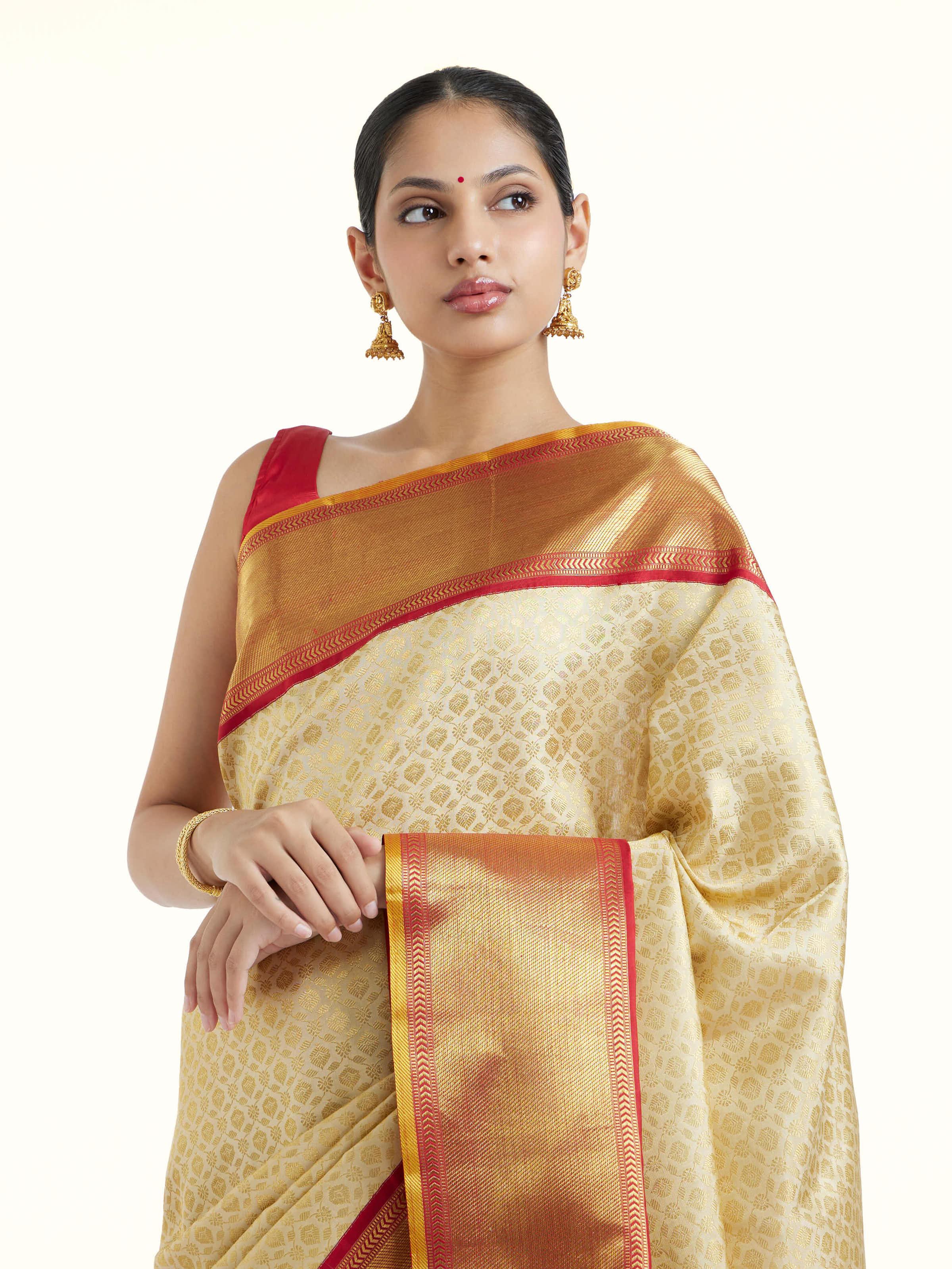 Angled view of peach silk Kancheepuram saree emphasizing weaving and finish